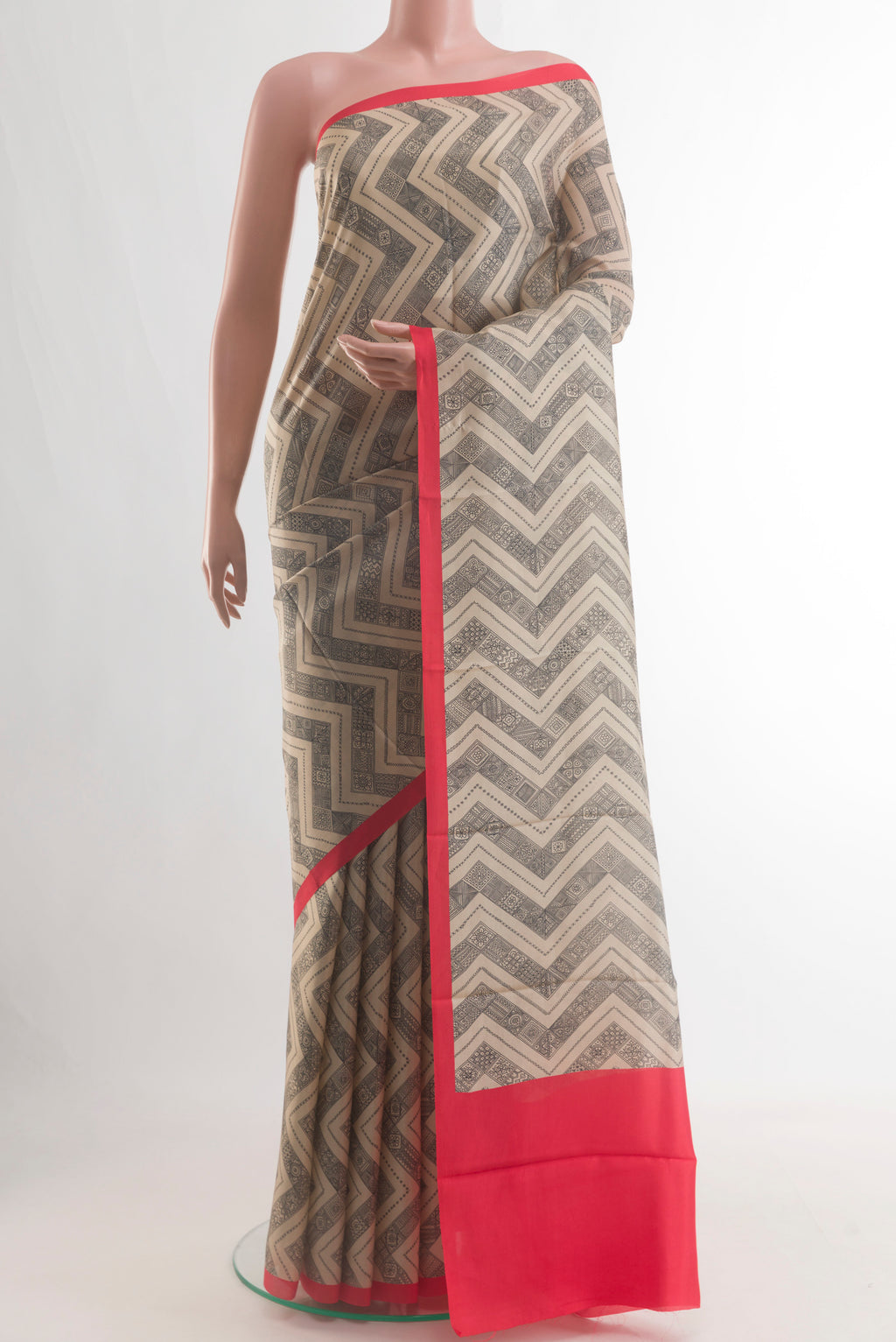 Beige Printed Silk Saree with Printed design on the body and Plain Border.  displayed on a mannequin