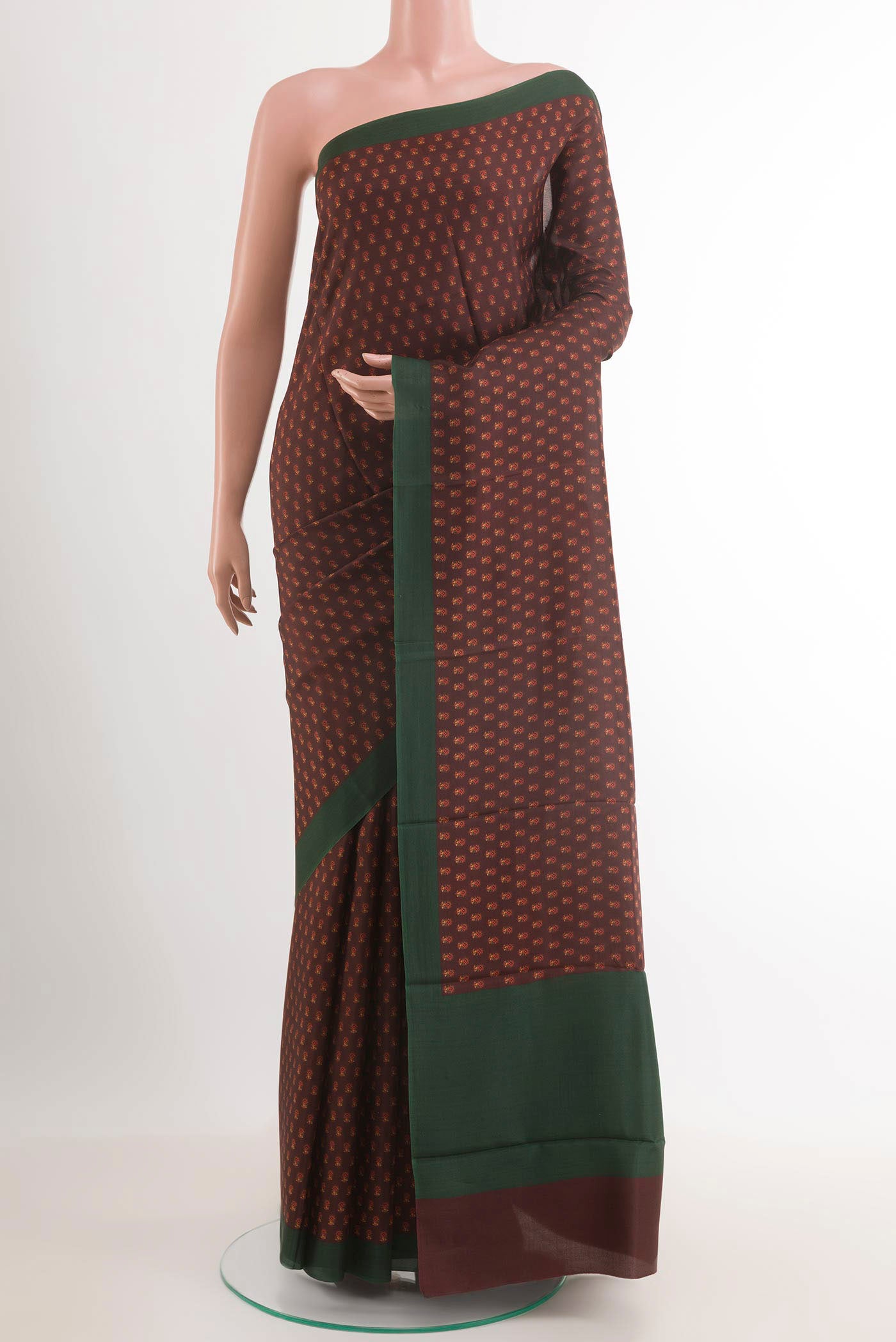 Brown Printed Silk Saree with Printed design on the body and Plain Border.  displayed on a mannequin