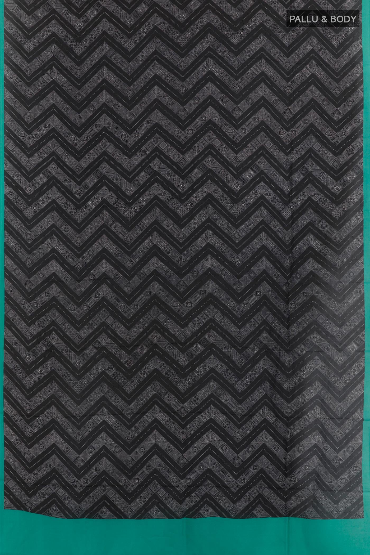 Flat view of Black Printed Silk Saree with Printed design on the body and Printed Border. 