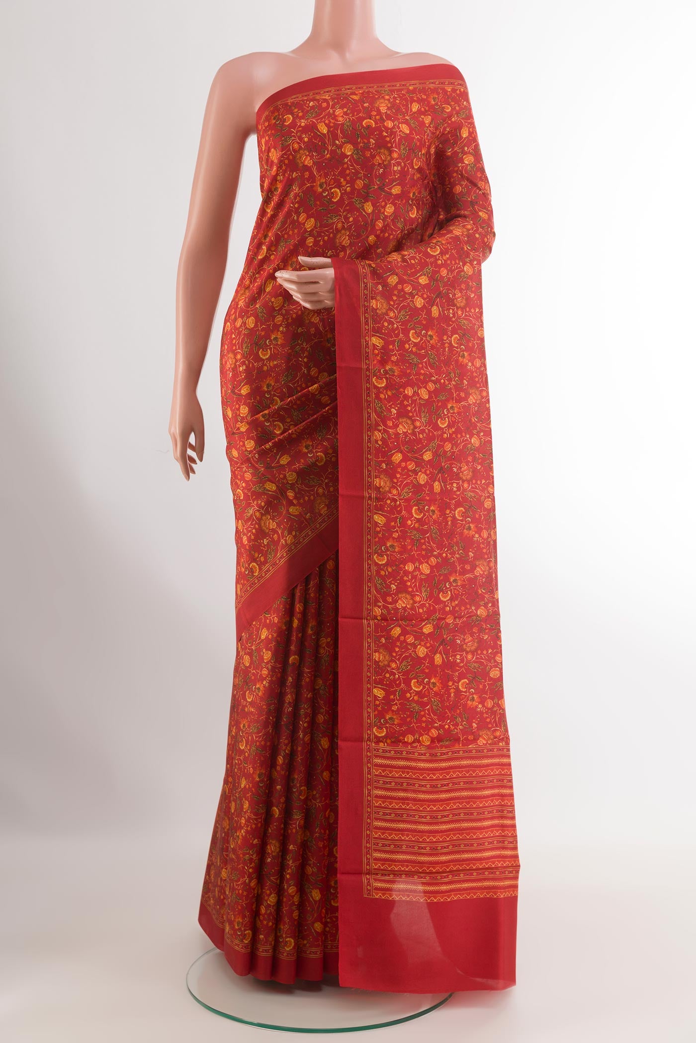 Red Printed Silk Saree with Printed design on the body and Printed Border.  displayed on a mannequin
