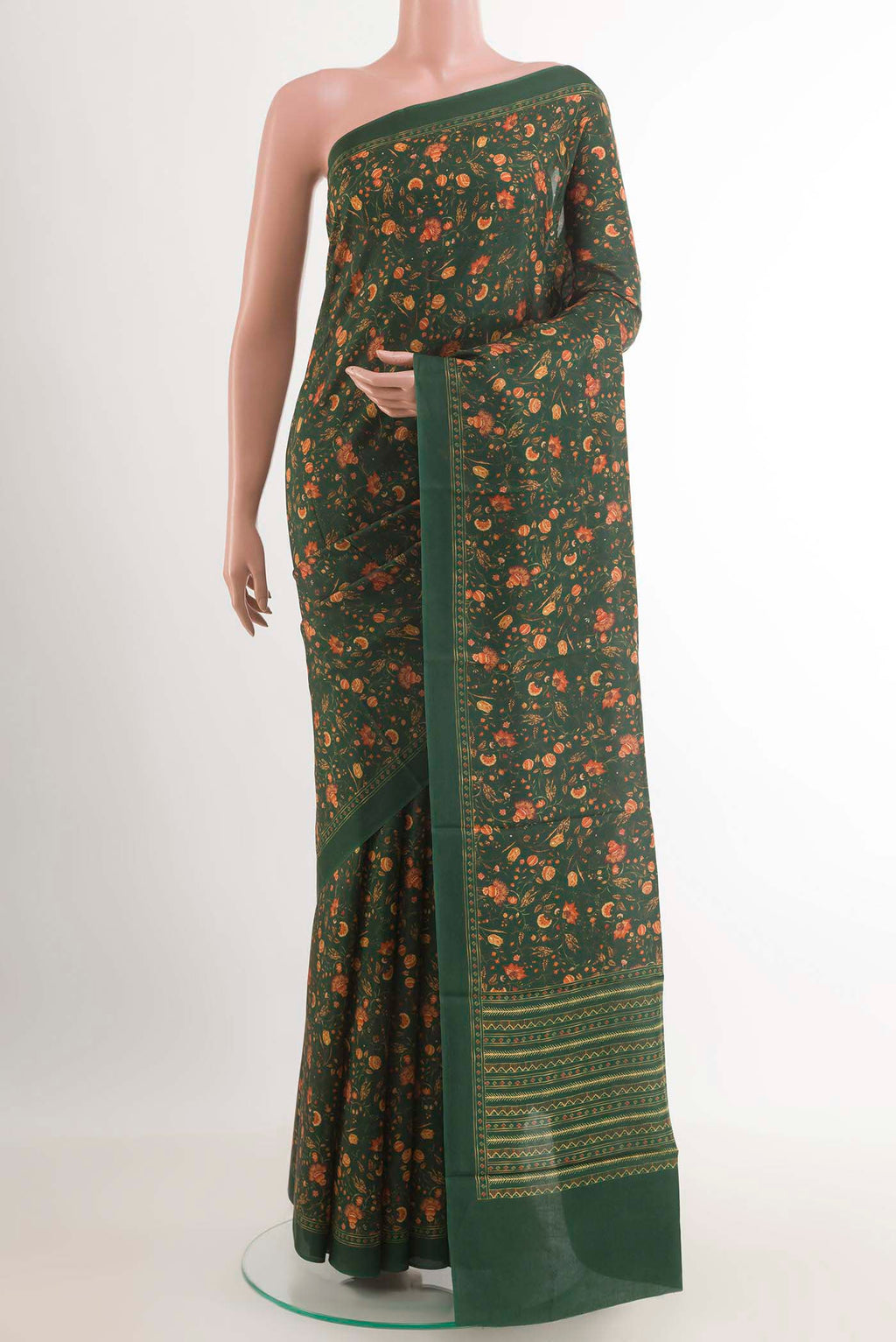 Green Printed Silk Saree with Printed design on the body and Plain Border.  displayed on a mannequin