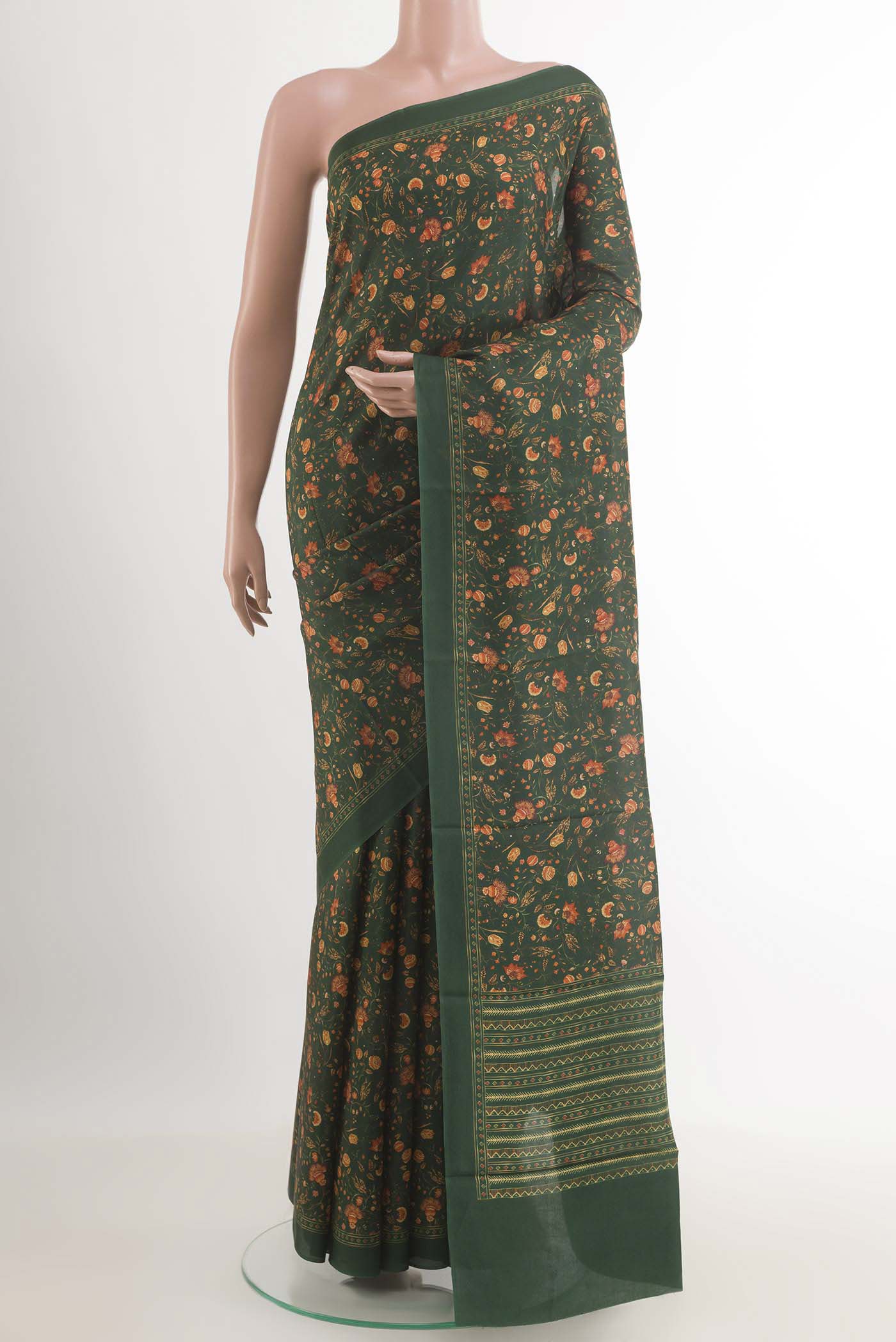 Green Printed Silk Saree with Printed design on the body and Plain Border.  displayed on a mannequin