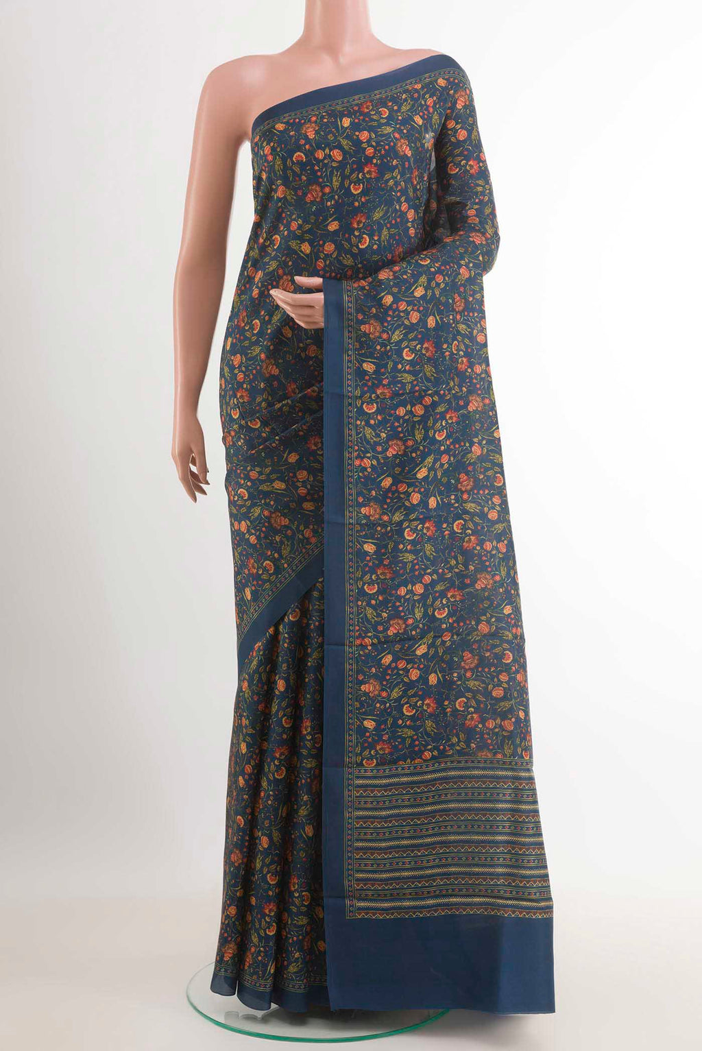 Blue Printed Silk Saree with Printed design on the body and Plain Border.  displayed on a mannequin