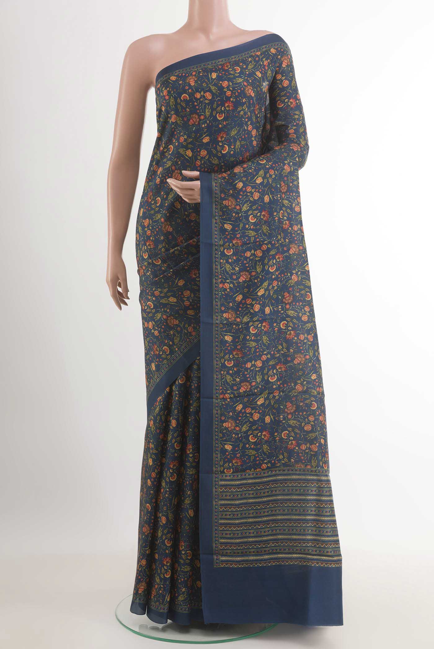 Blue Printed Silk Saree with Printed design on the body and Plain Border.  displayed on a mannequin