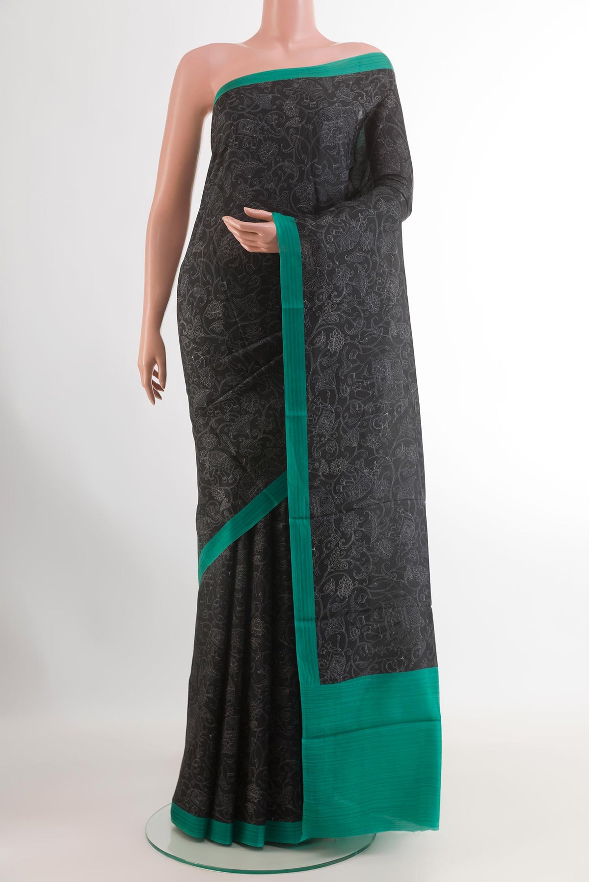 Black Printed Silk Saree with Printed design on the body and Printed Border.  displayed on a mannequin