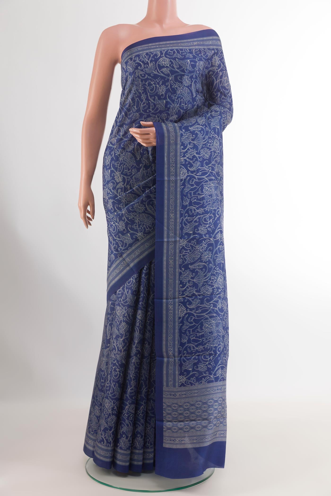 Blue Printed Silk Saree with Printed design on the body and Printed Border.  displayed on a mannequin