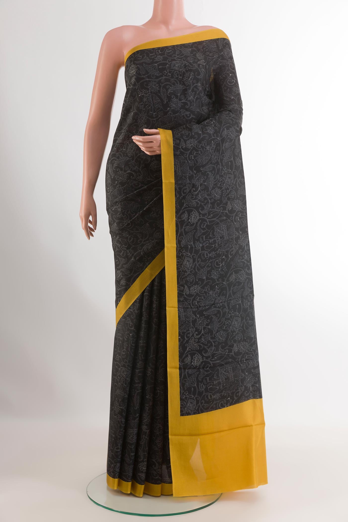 Black Printed Silk Saree with Printed design on the body and Printed Border.  displayed on a mannequin