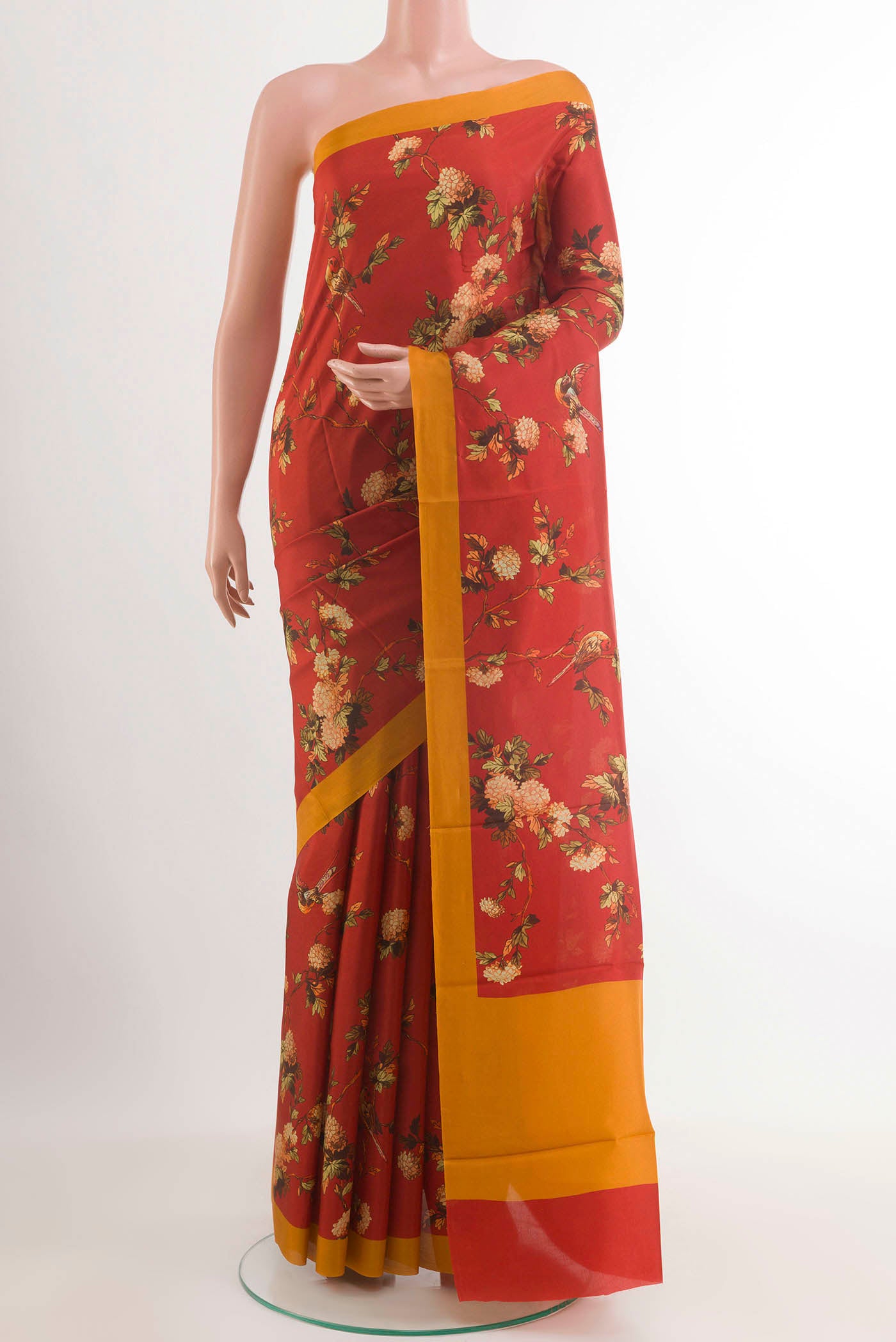 Red Printed Silk Saree with Printed design on the body and Plain Border.  displayed on a mannequin