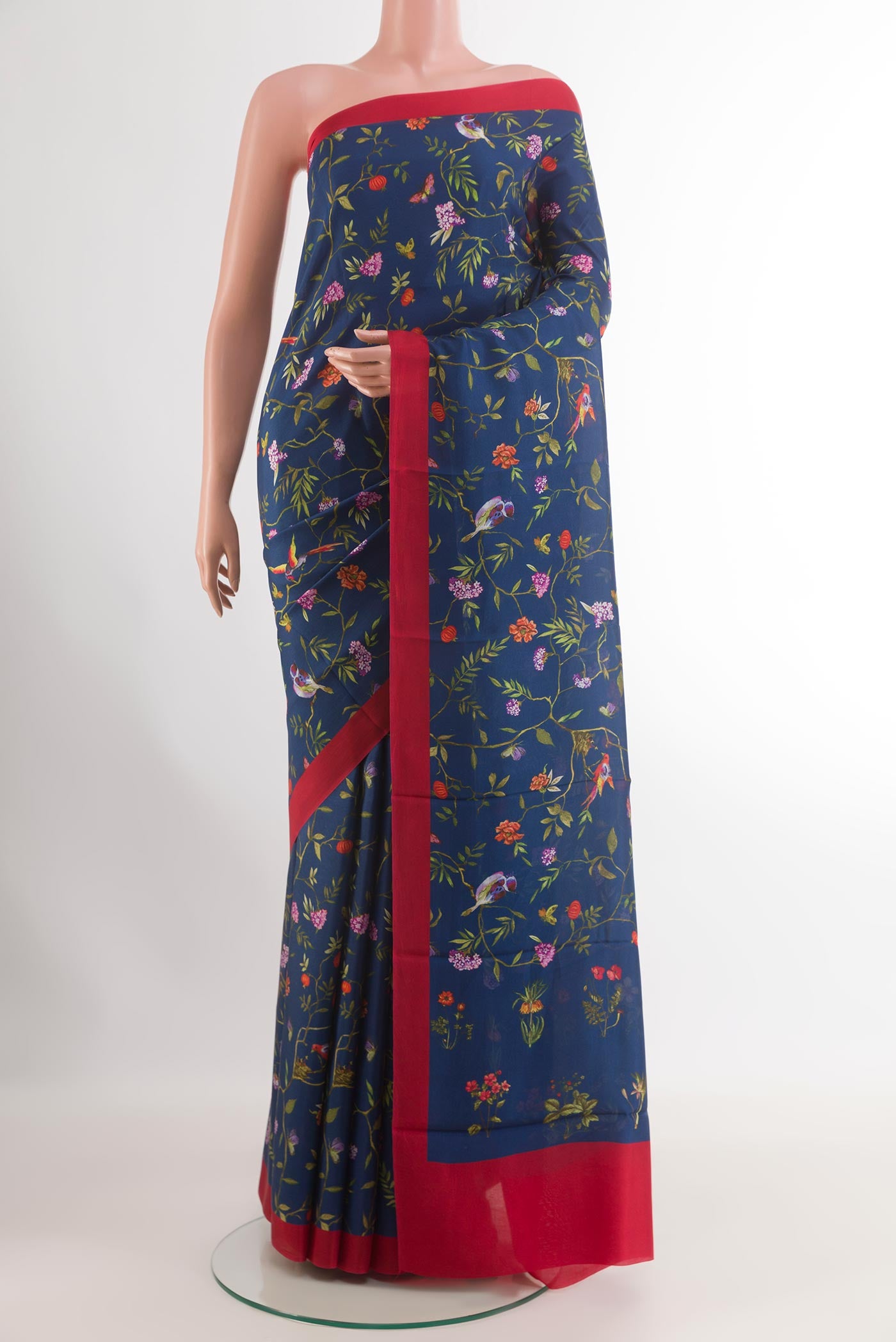 Blue Printed Silk Saree with Printed design on the body and Printed Border.  displayed on a mannequin