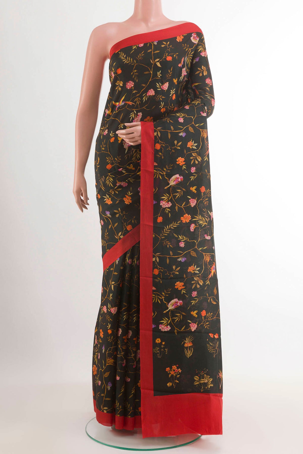 Black Printed Silk Saree with Printed design on the body and Plain Border.  displayed on a mannequin