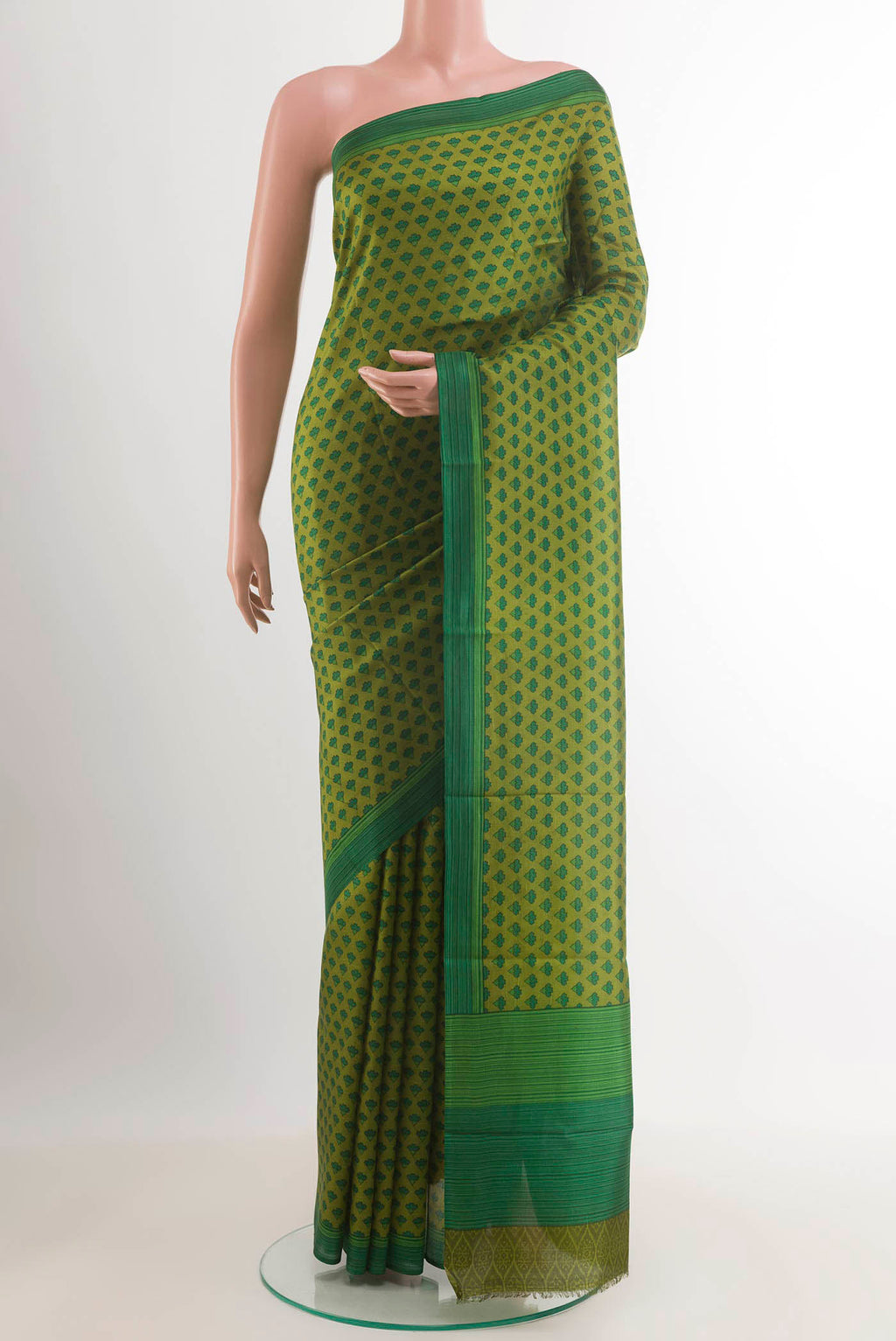 Green Printed Silk Saree with Printed design on the body and Plain Border.  displayed on a mannequin