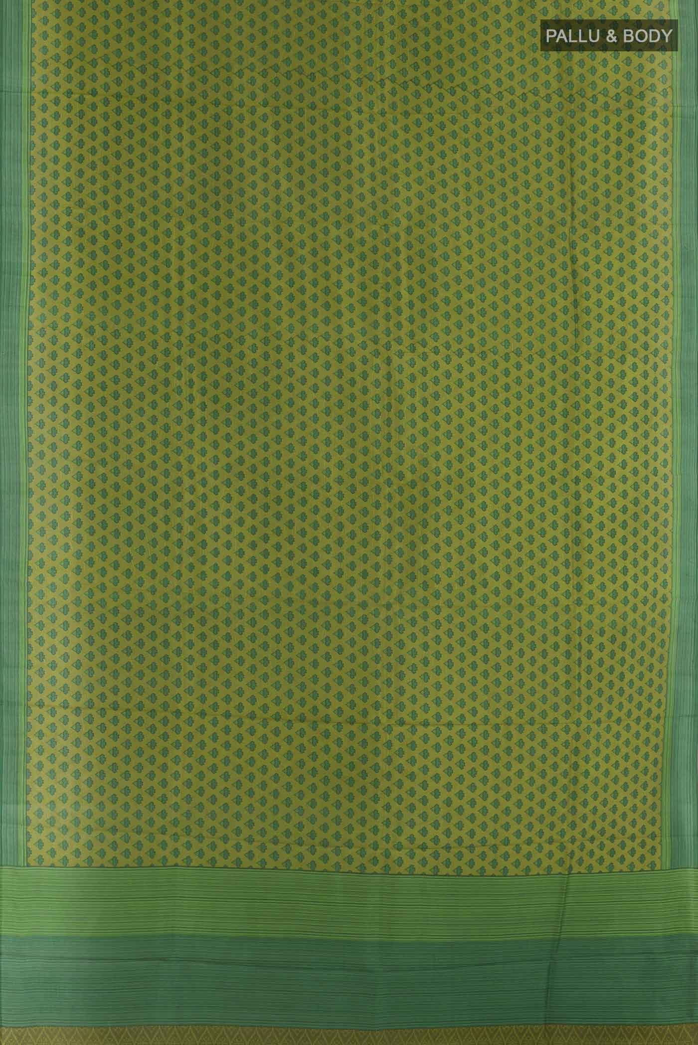 Flat view of Green Printed Silk Saree with Printed design on the body and Plain Border. 