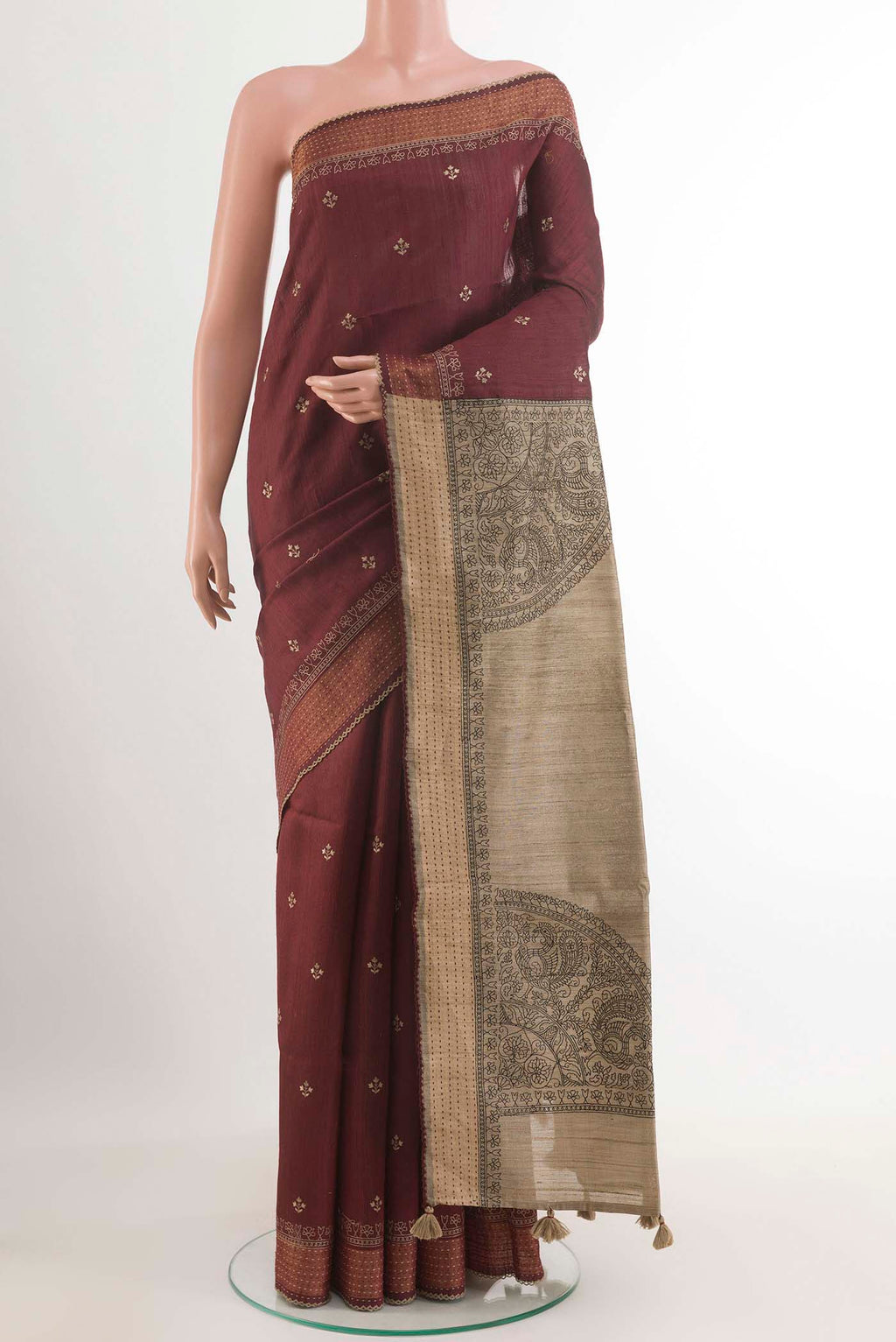 Maroon Tussar Saree with Thread Butta on the body and Zari Border.  displayed on a mannequin