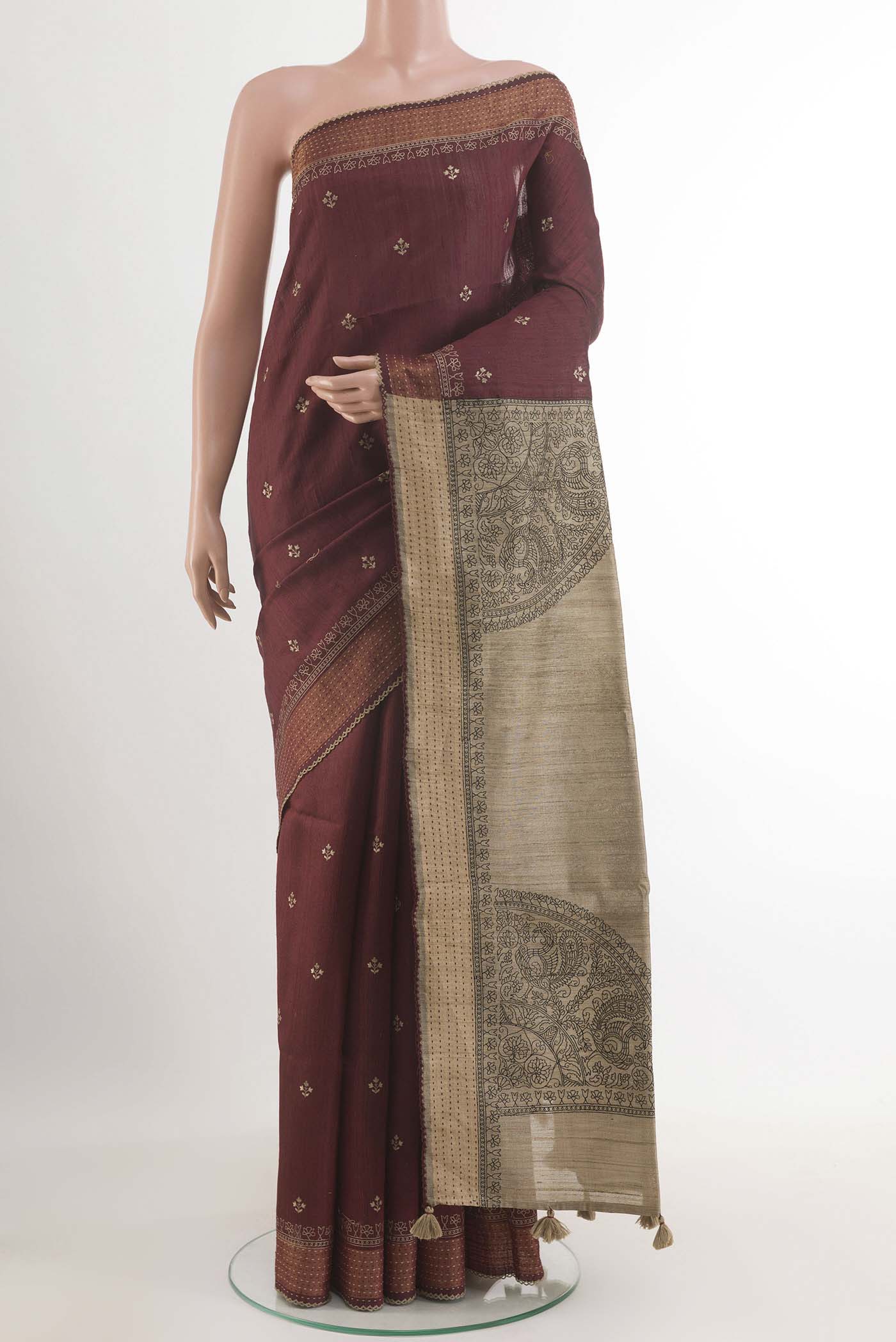 Maroon Tussar Saree with Thread Butta on the body and Zari Border.  displayed on a mannequin