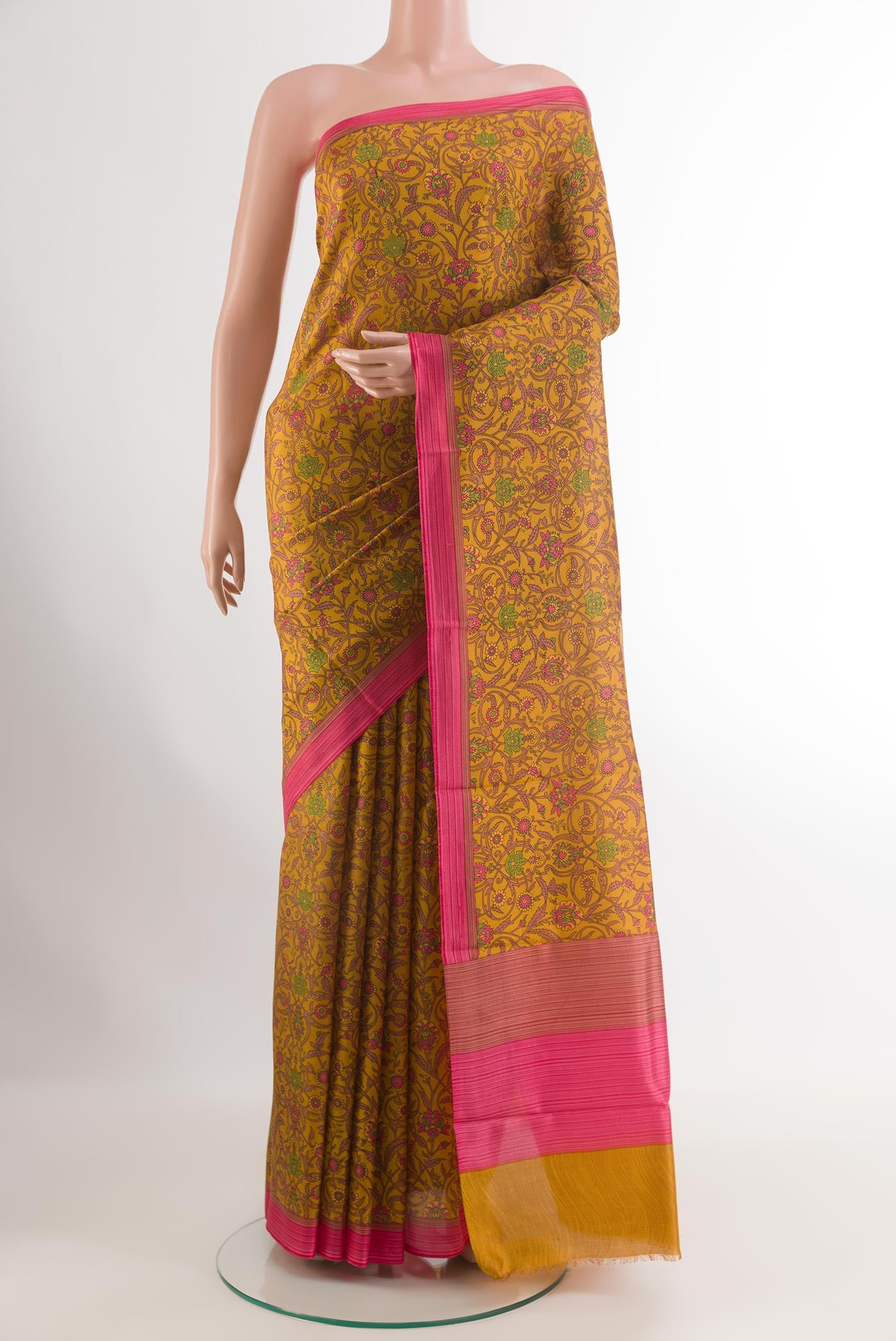 Mustard Printed Silk Saree with Printed design on the body and Printed Border.  displayed on a mannequin