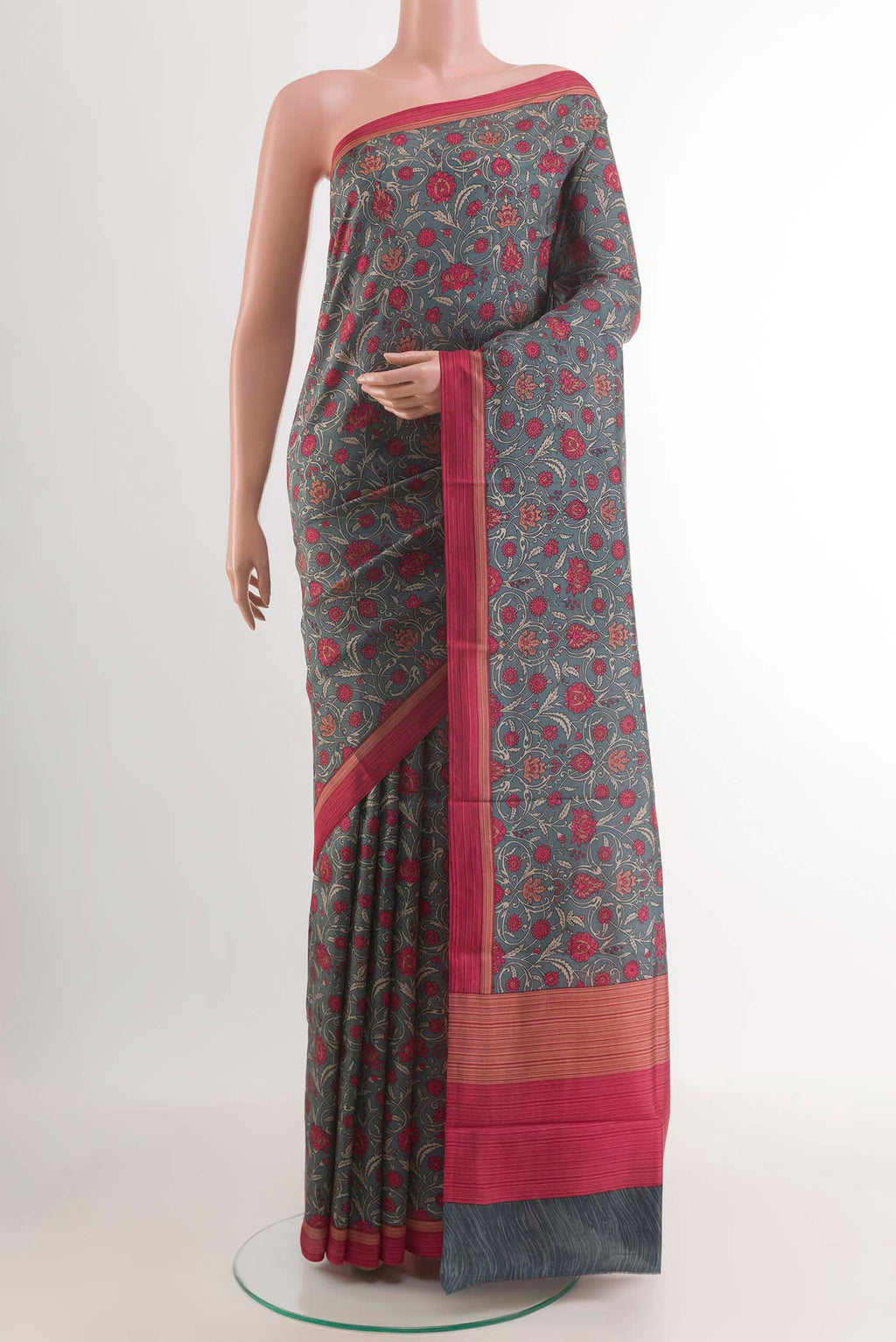 Grey Printed Silk Saree with Printed design on the body and Plain Border.  displayed on a mannequin