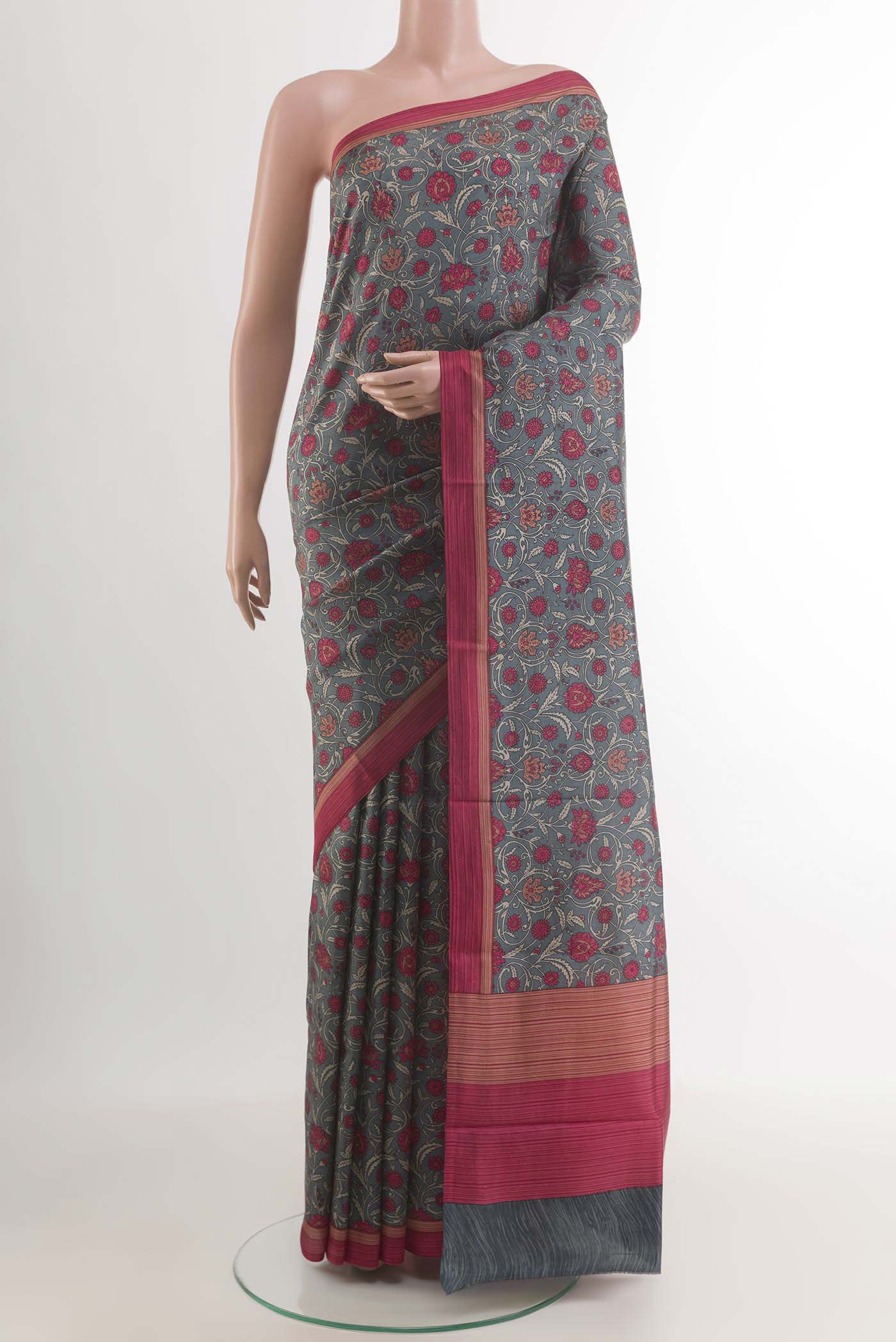 Grey Printed Silk Saree with Printed design on the body and Plain Border.  displayed on a mannequin