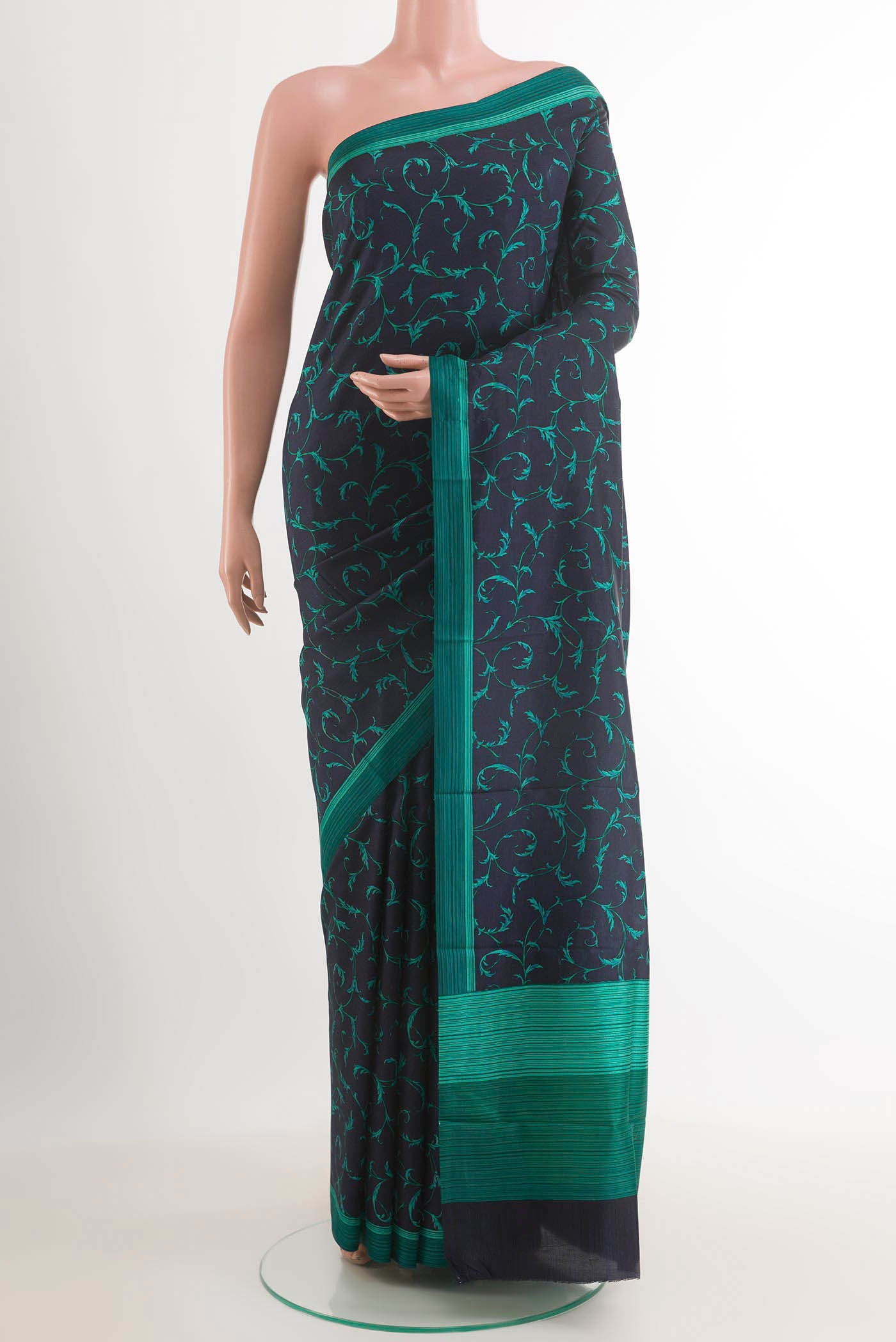 Dark Blue Printed Silk Saree with Printed design on the body and Printed Border.  displayed on a mannequin