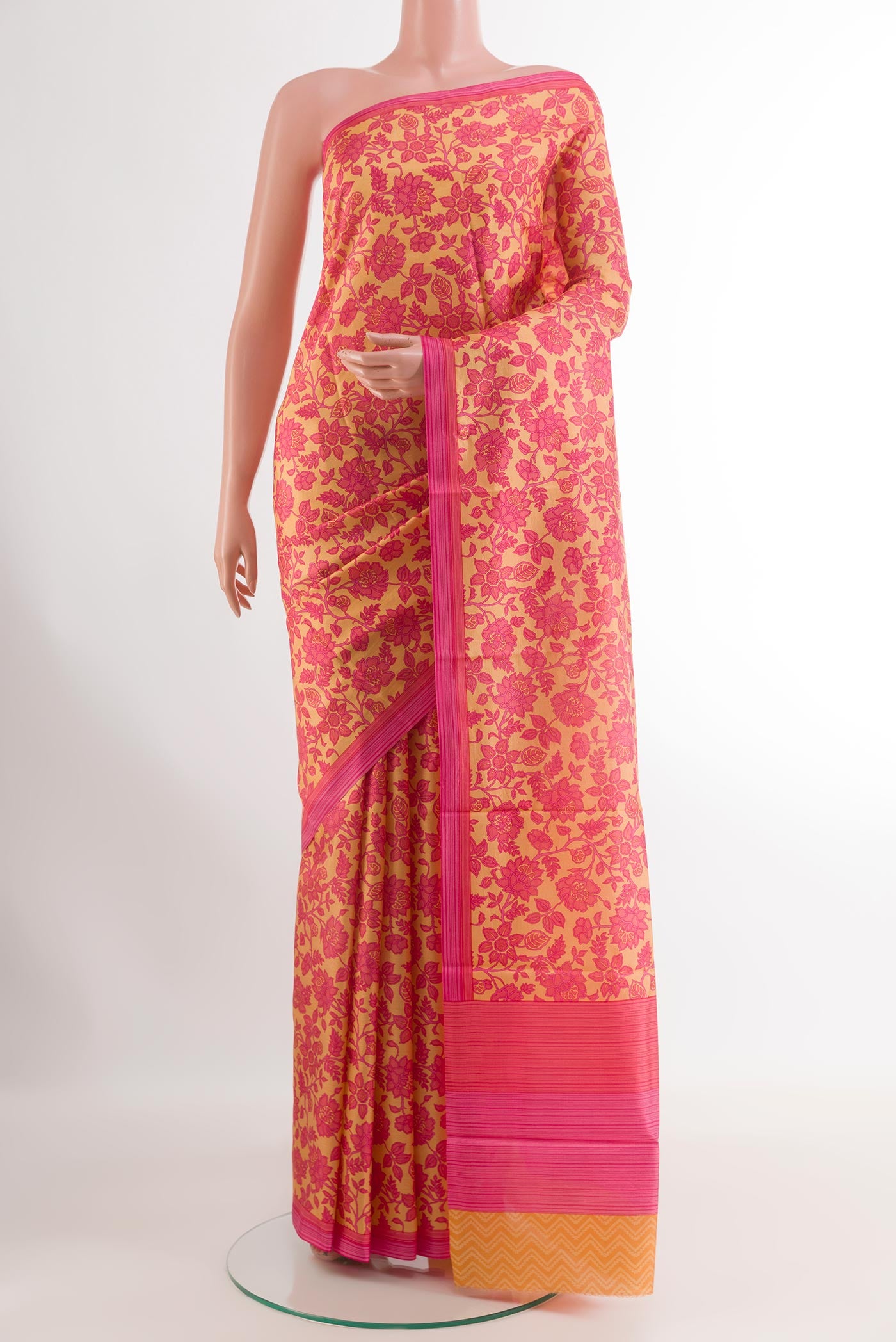 Cream Printed Silk Saree with Printed design on the body and Printed Border.  displayed on a mannequin