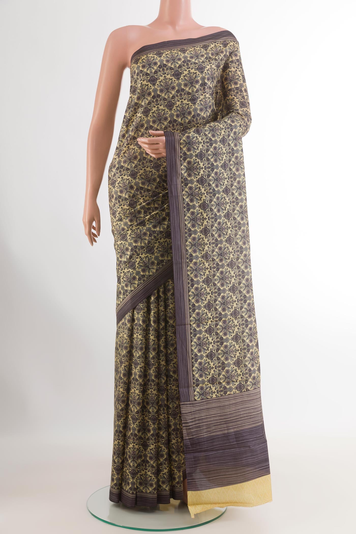 Lemon Yellow Printed Silk Saree with Printed design on the body and Printed Border.  displayed on a mannequin