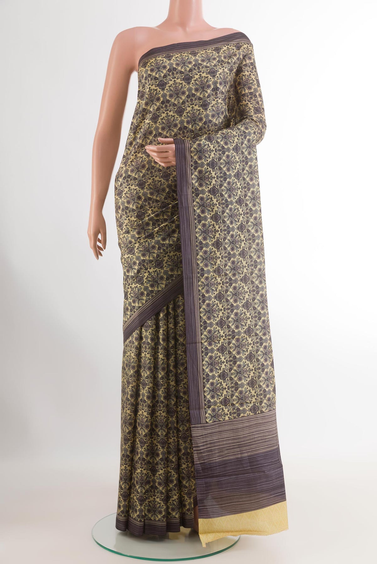 Lemon Yellow Printed Silk Saree with Printed design on the body and Printed Border.  displayed on a mannequin