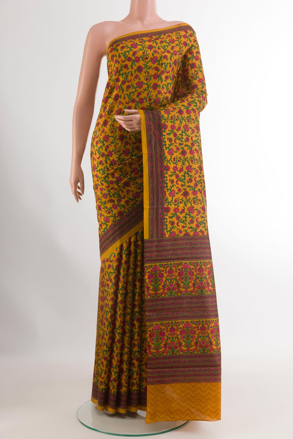 Mustard Printed Silk Saree with Printed design on the body and Printed Border.  displayed on a mannequin
