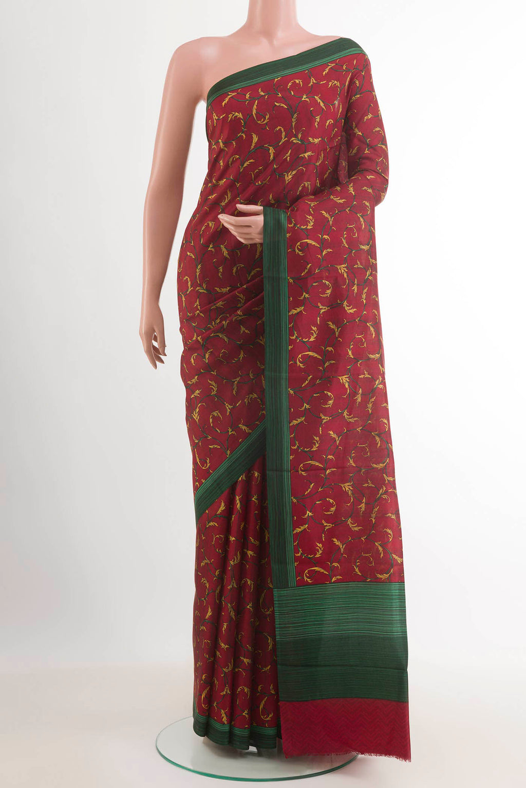 Maroon Printed Silk Saree with Printed design on the body and Printed Border.  displayed on a mannequin