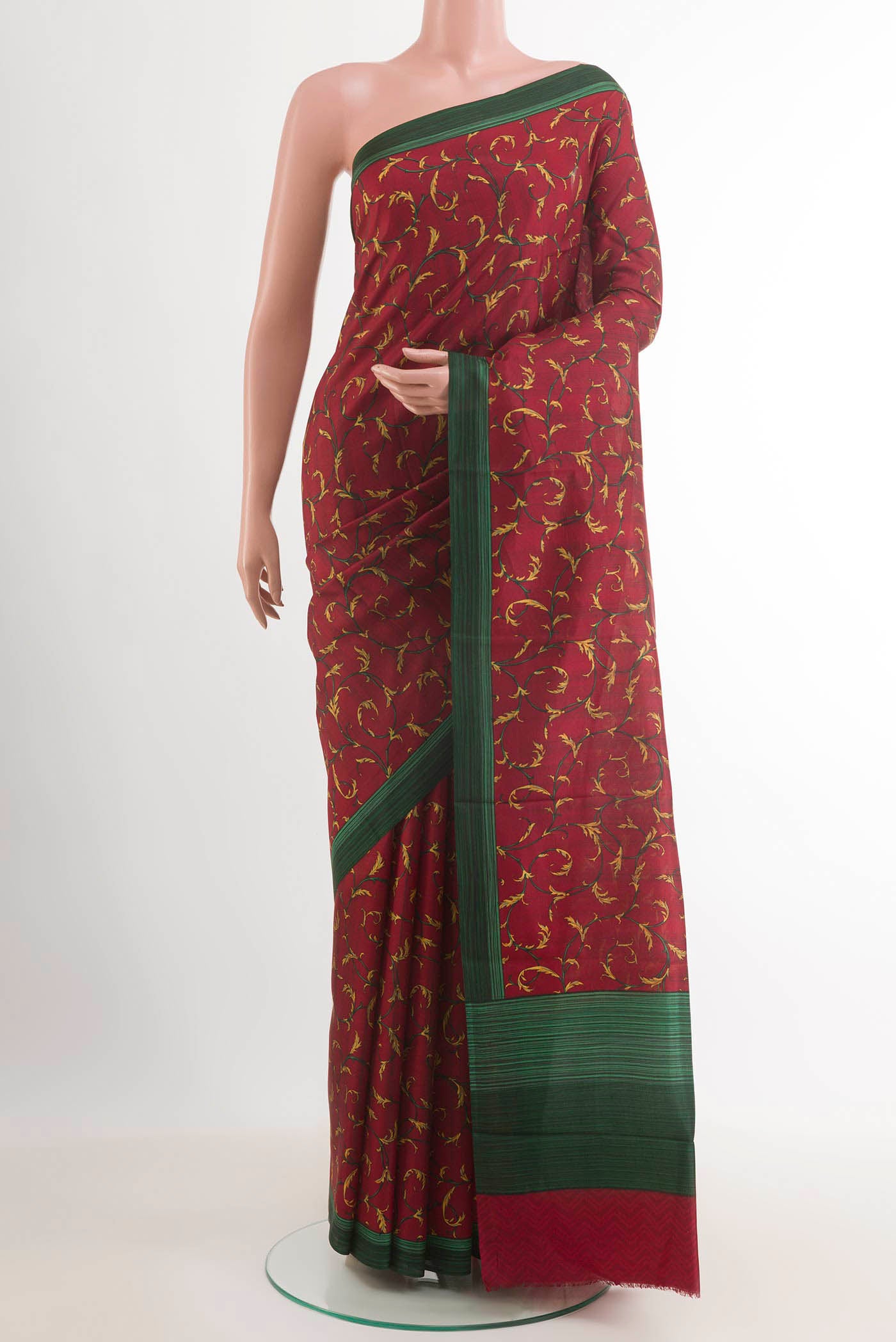Maroon Printed Silk Saree with Printed design on the body and Printed Border.  displayed on a mannequin