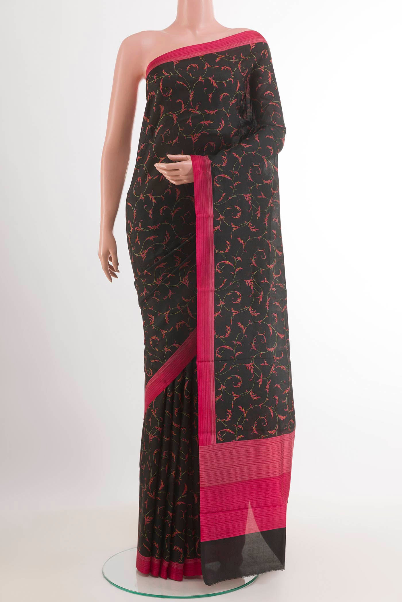 Black Printed Silk Saree with Printed design on the body and Printed Border.  displayed on a mannequin