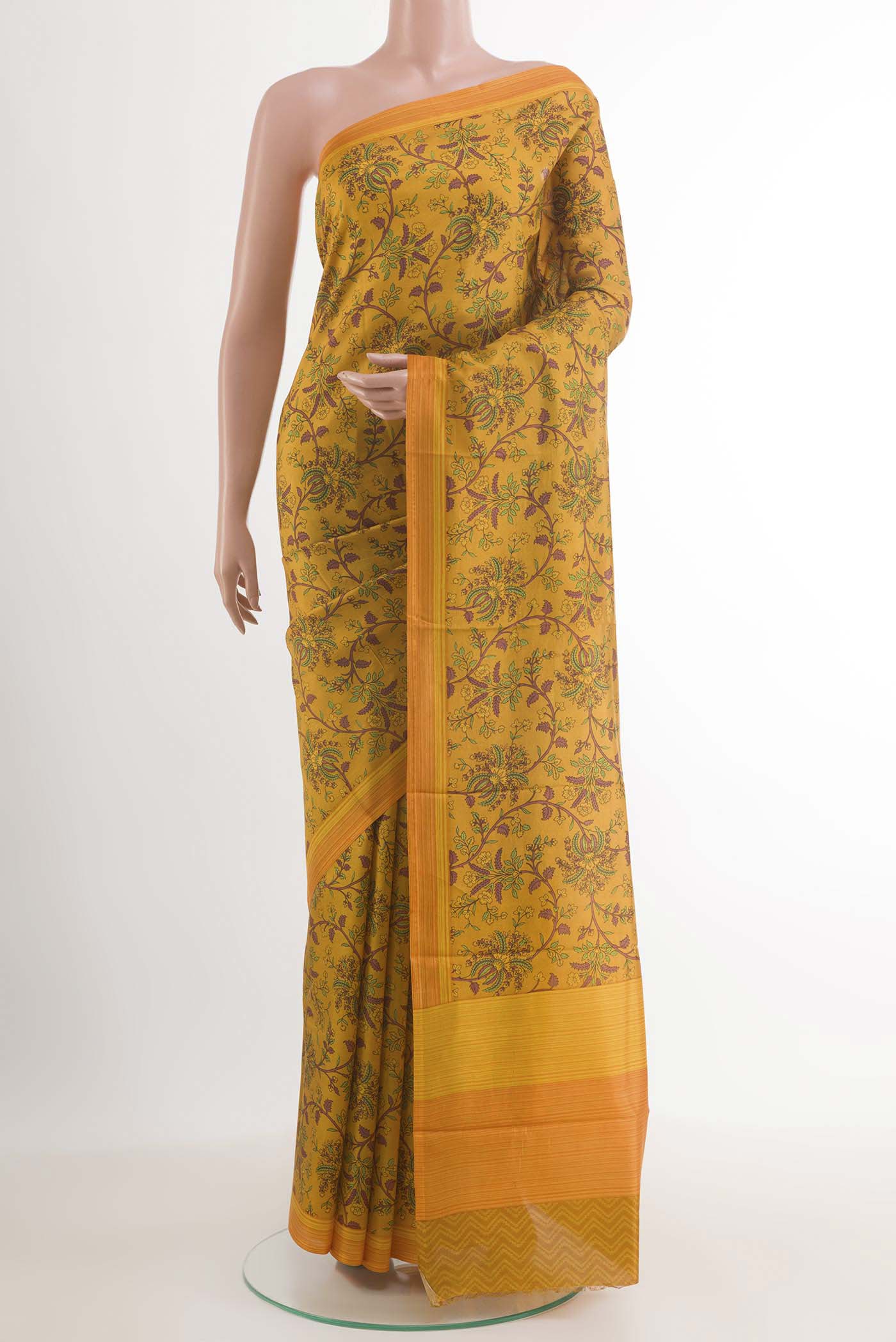 Yellow Printed Silk Saree with Printed design on the body and Printed Border.  displayed on a mannequin