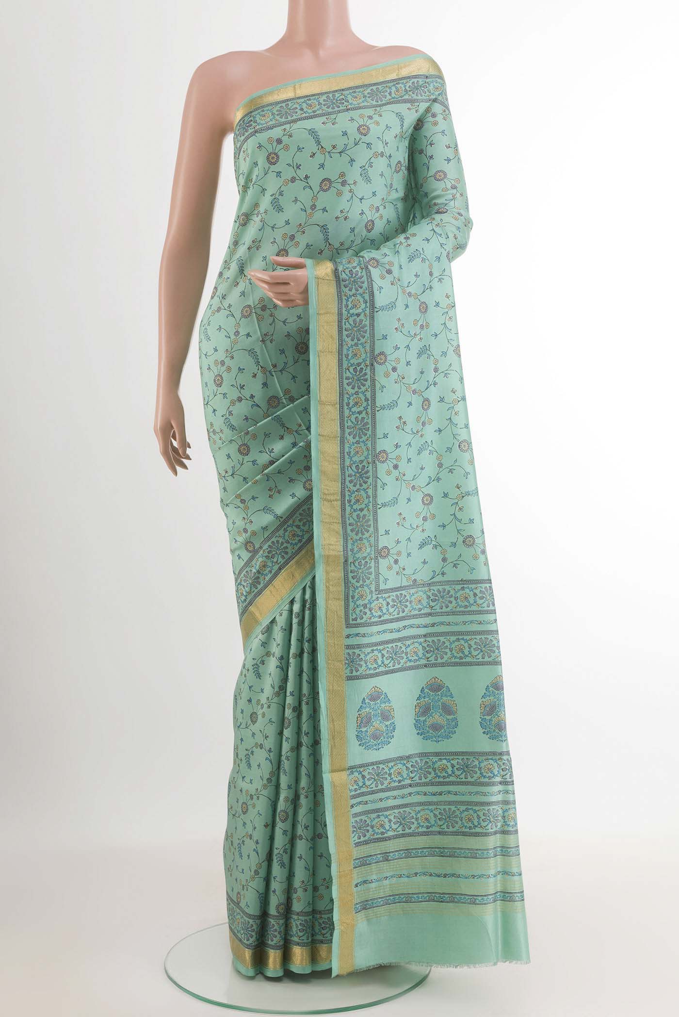 Blue Printed Silk Saree with Printed design on the body and Zari Border.  displayed on a mannequin