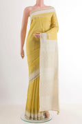 Yellow Tussar Saree with Zari Butta on the body and Zari Border.  displayed on a mannequin