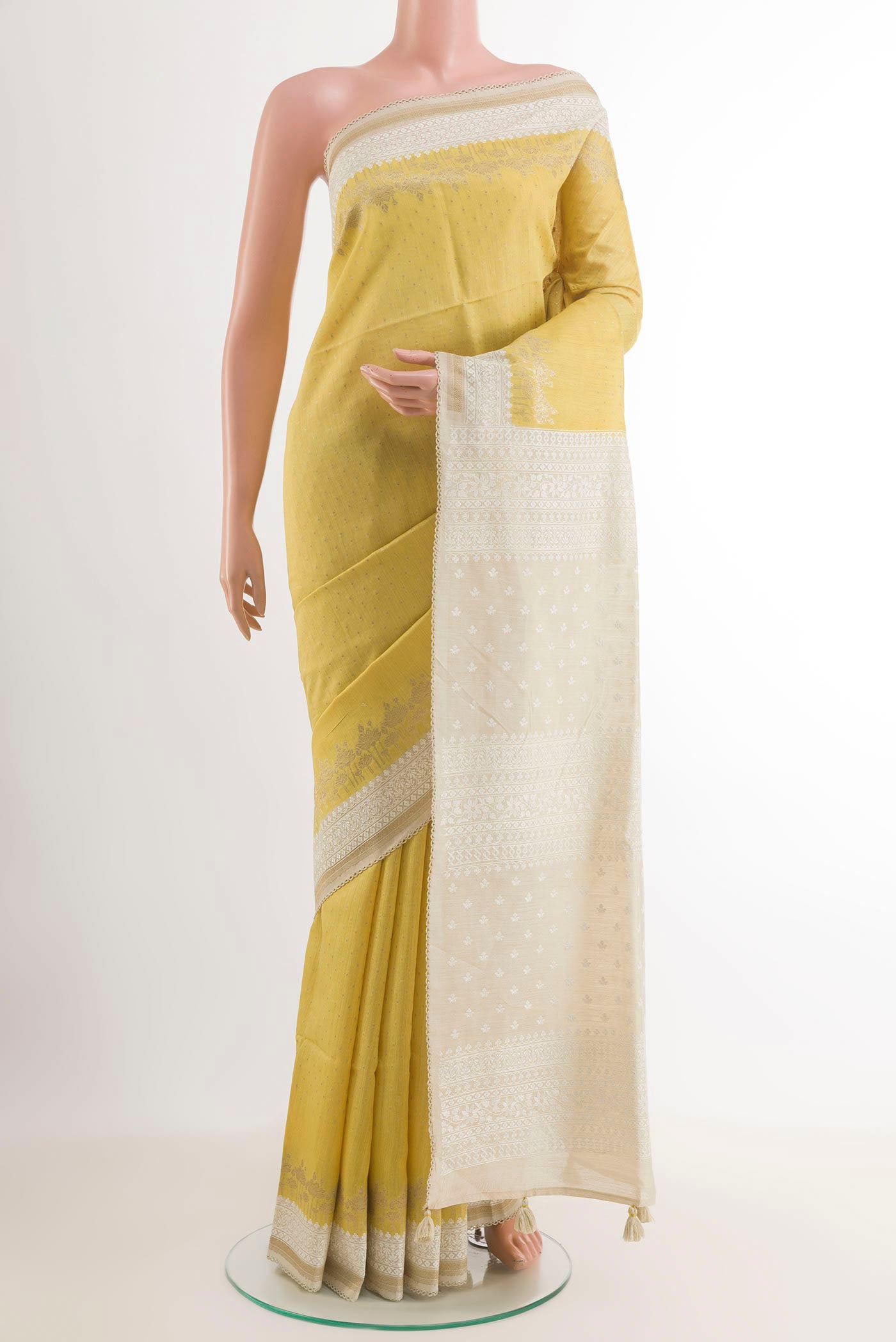 Yellow Tussar Saree with Zari Butta on the body and Zari Border.  displayed on a mannequin