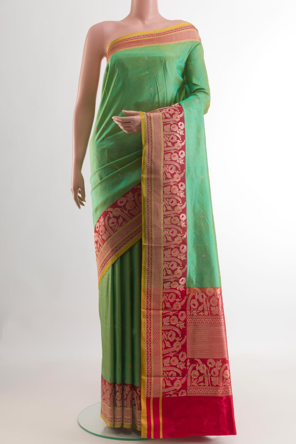 Green Banarasi Katan Silk Saree with Zari Butta on the body and Zari Border.  displayed on a mannequin