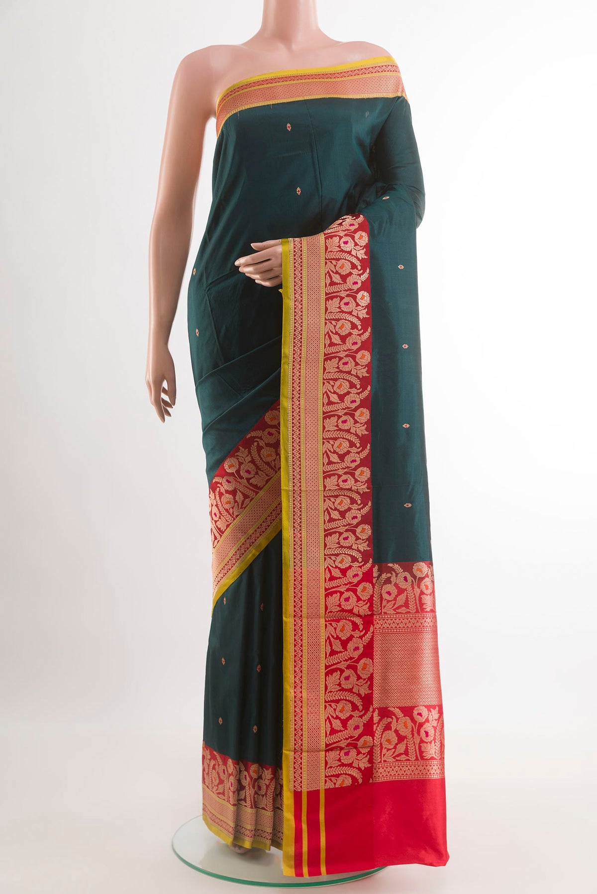 Bottle Green Banarasi Katan Silk Saree with Zari Butta on the body and Zari Border.  displayed on a mannequin