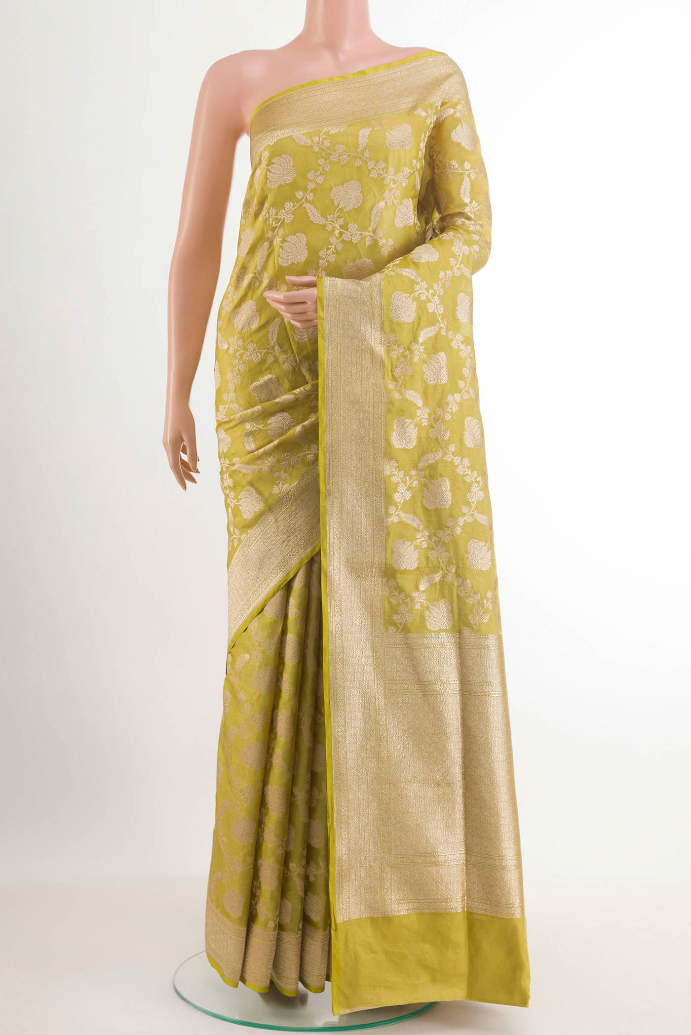 Green Banarasi Silk Saree with Zari Brocade on the body and Zari Border.  displayed on a mannequin