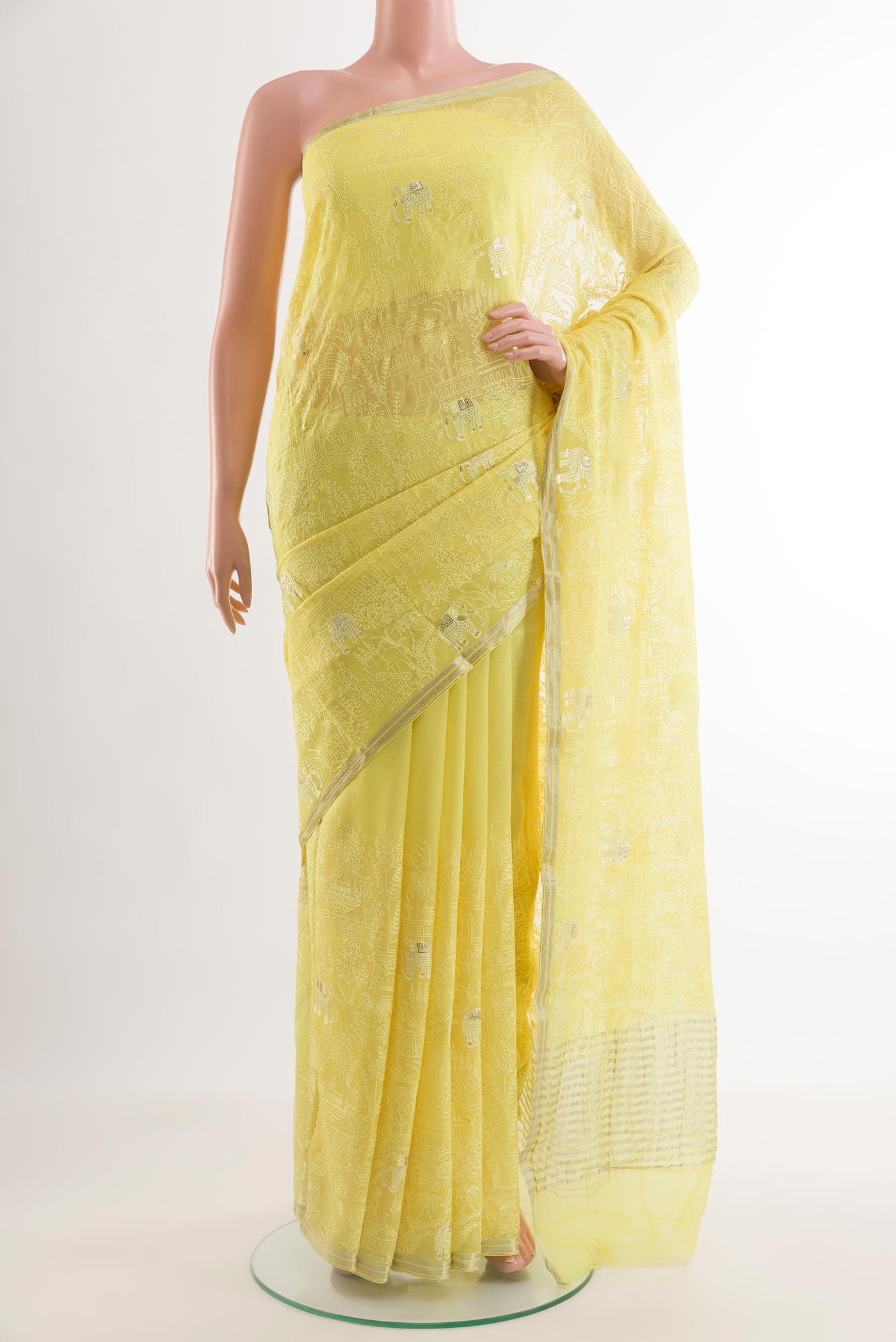Lemon Yellow Mysore Chiffon Saree with Embroidery on the body and Zari Border.  displayed on a mannequin