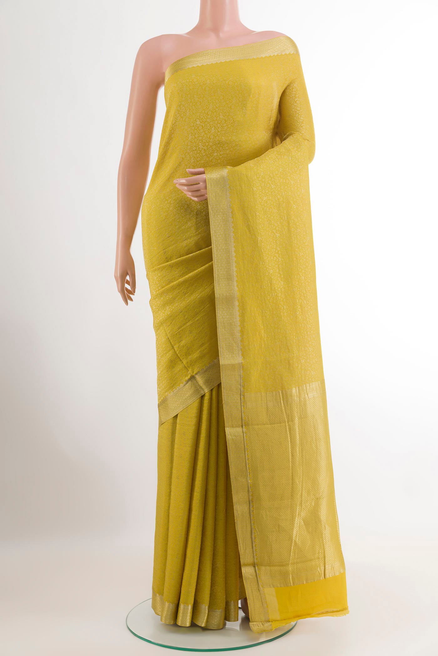 Yellow Mysore Crepe Saree with Zari Brocade on the body and Zari Border.  displayed on a mannequin