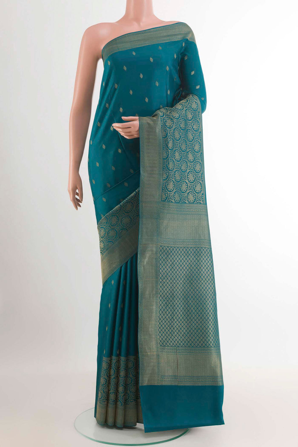 Peacock Blue Mysore Crepe Saree with Zari Butta on the body and Zari Border.  displayed on a mannequin
