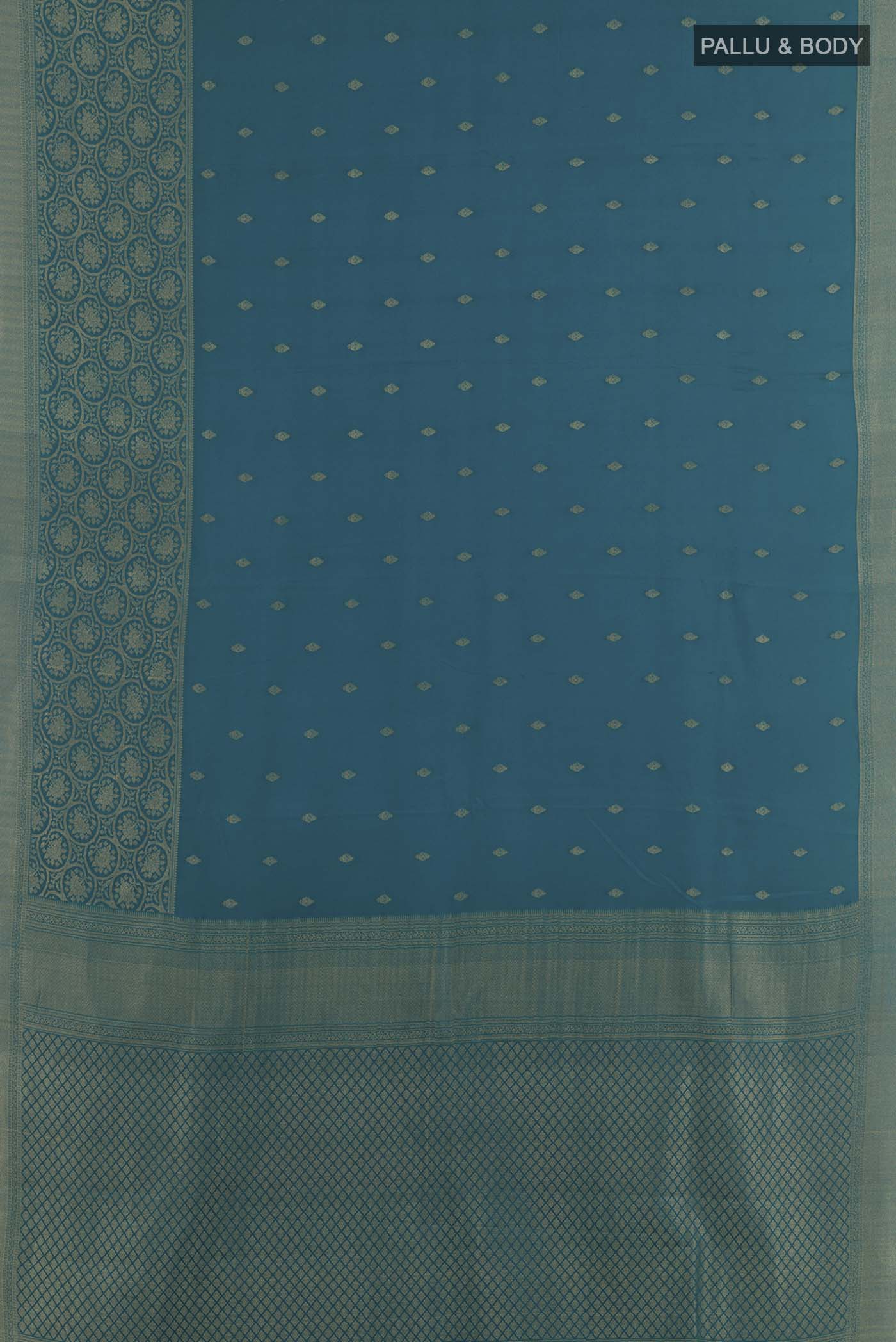 Flat view of Peacock Blue Mysore Crepe Saree with Zari Butta on the body and Zari Border. 