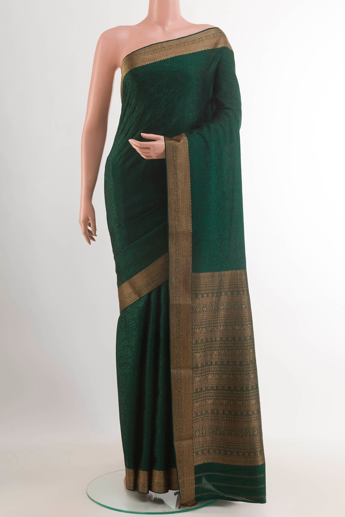 Bottle Green Mysore Crepe Saree with Jacquard design on the body and Zari Border.  displayed on a mannequin