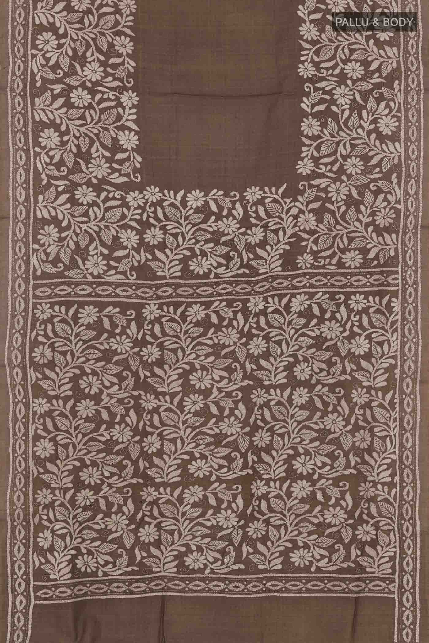 Flat view of Brown Tussar Saree with Kantha Work on the body and Embroidery Border. 