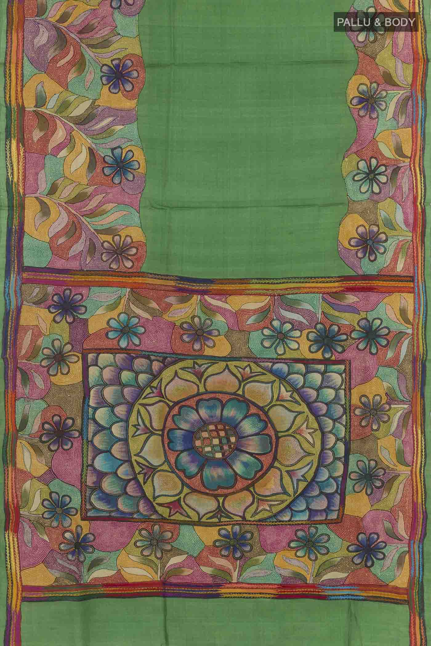 Flat view of Green Tussar Saree with Kantha Work on the body and Embroidery Border. 