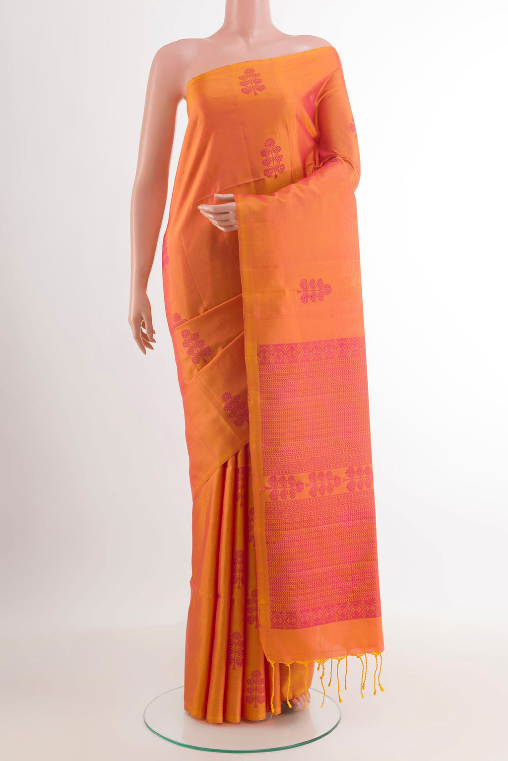 Mustard Soft Silk Saree with Jacquard design on the body and Zari Border.  displayed on a mannequin