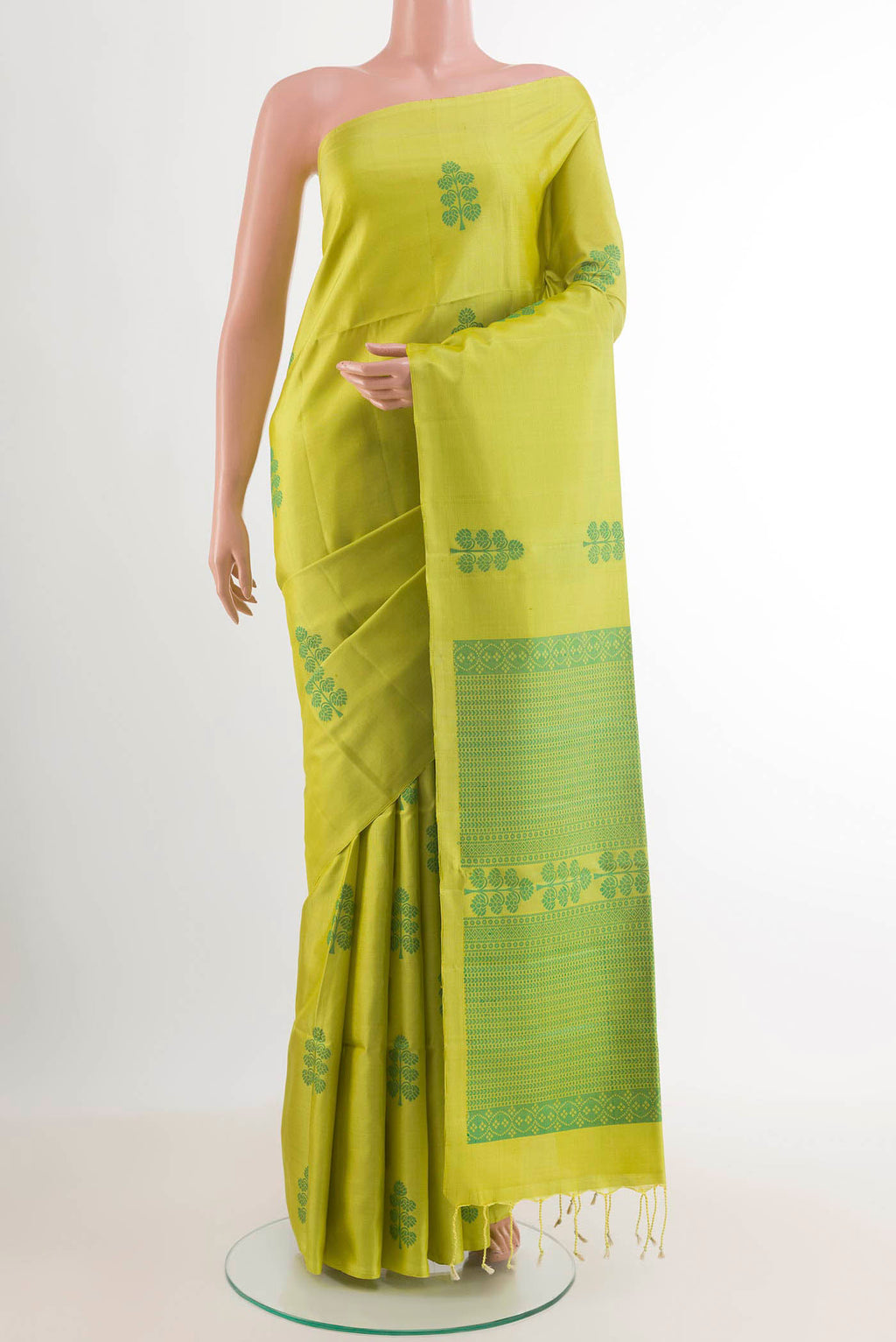 Green Soft Silk Saree with Jacquard design on the body and Zari Border.  displayed on a mannequin
