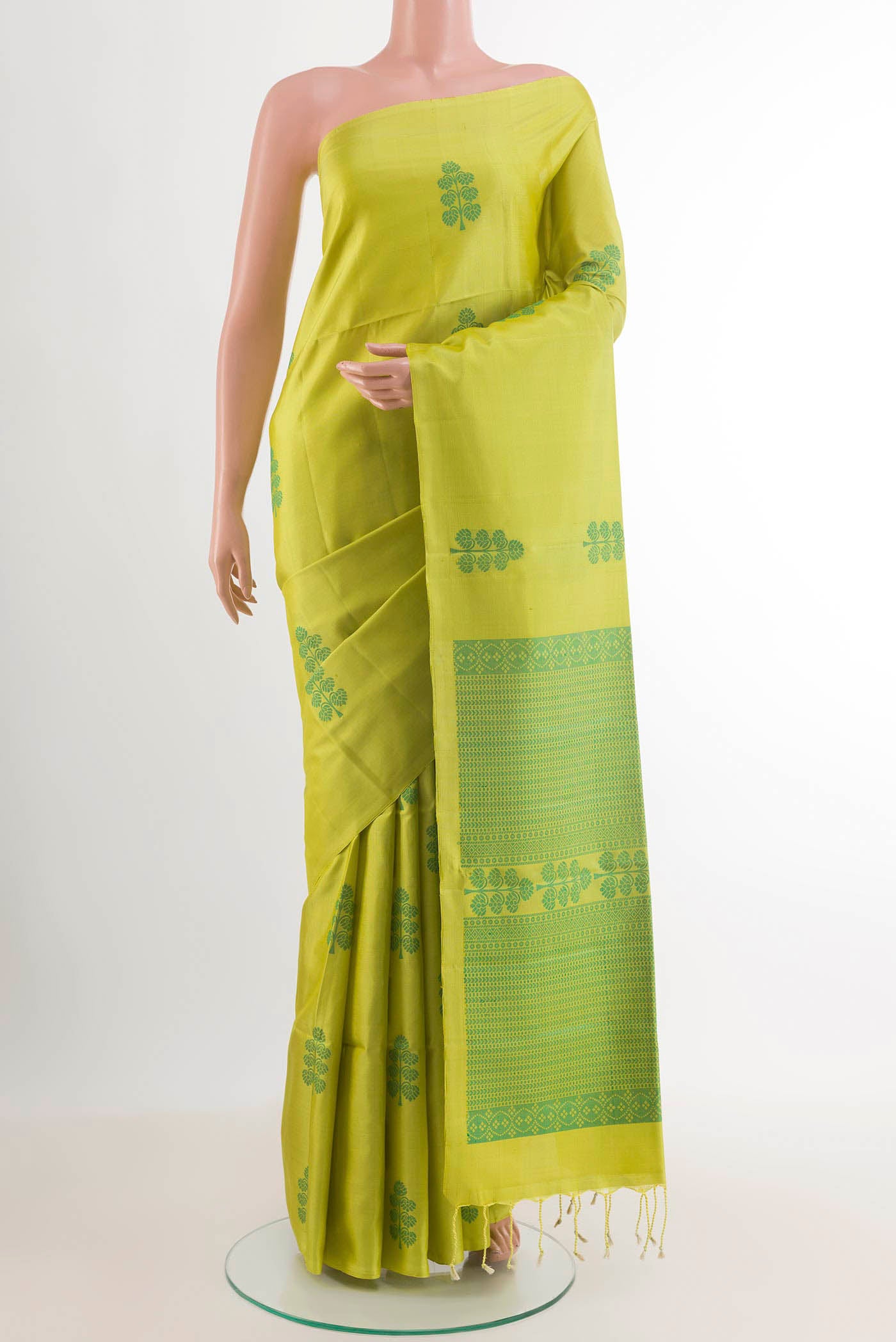 Green Soft Silk Saree with Jacquard design on the body and Zari Border.  displayed on a mannequin