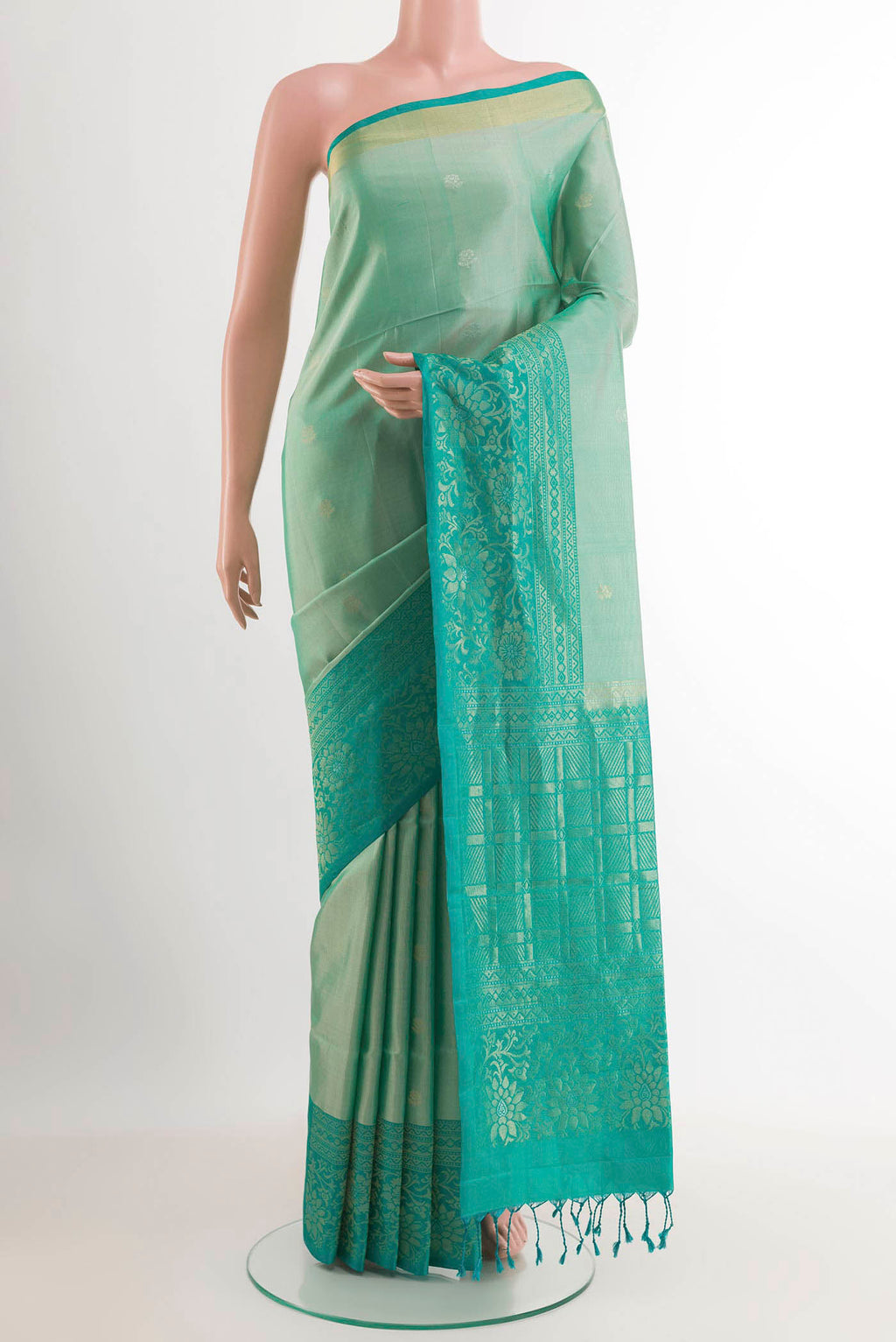 Sage Green Soft Silk Saree with Zari Butta on the body and Zari Border.  displayed on a mannequin