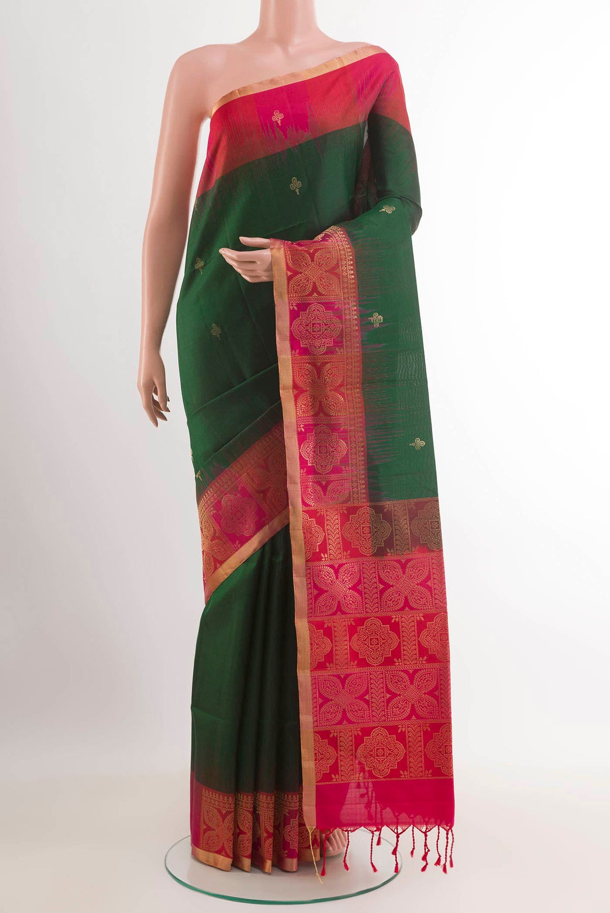 Green Soft Silk Saree with Zari Butta on the body and Zari Border.  displayed on a mannequin