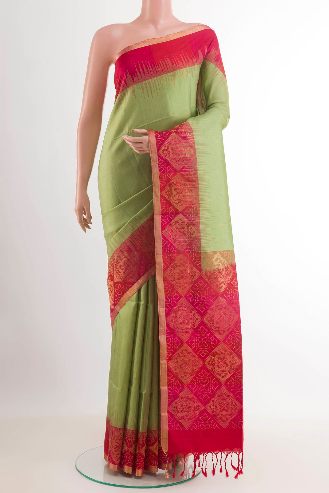 Green Soft Silk Saree with Zari Butta on the body and Zari Border.  displayed on a mannequin