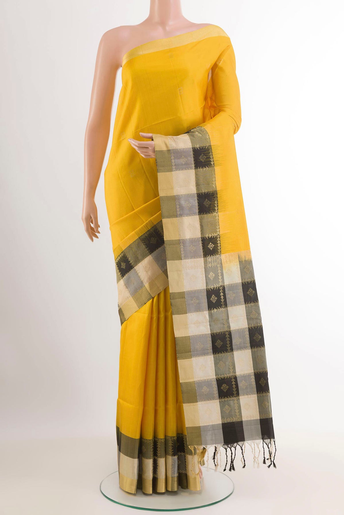 Yellow Soft Silk Saree with Zari Butta on the body and Zari Border.  displayed on a mannequin